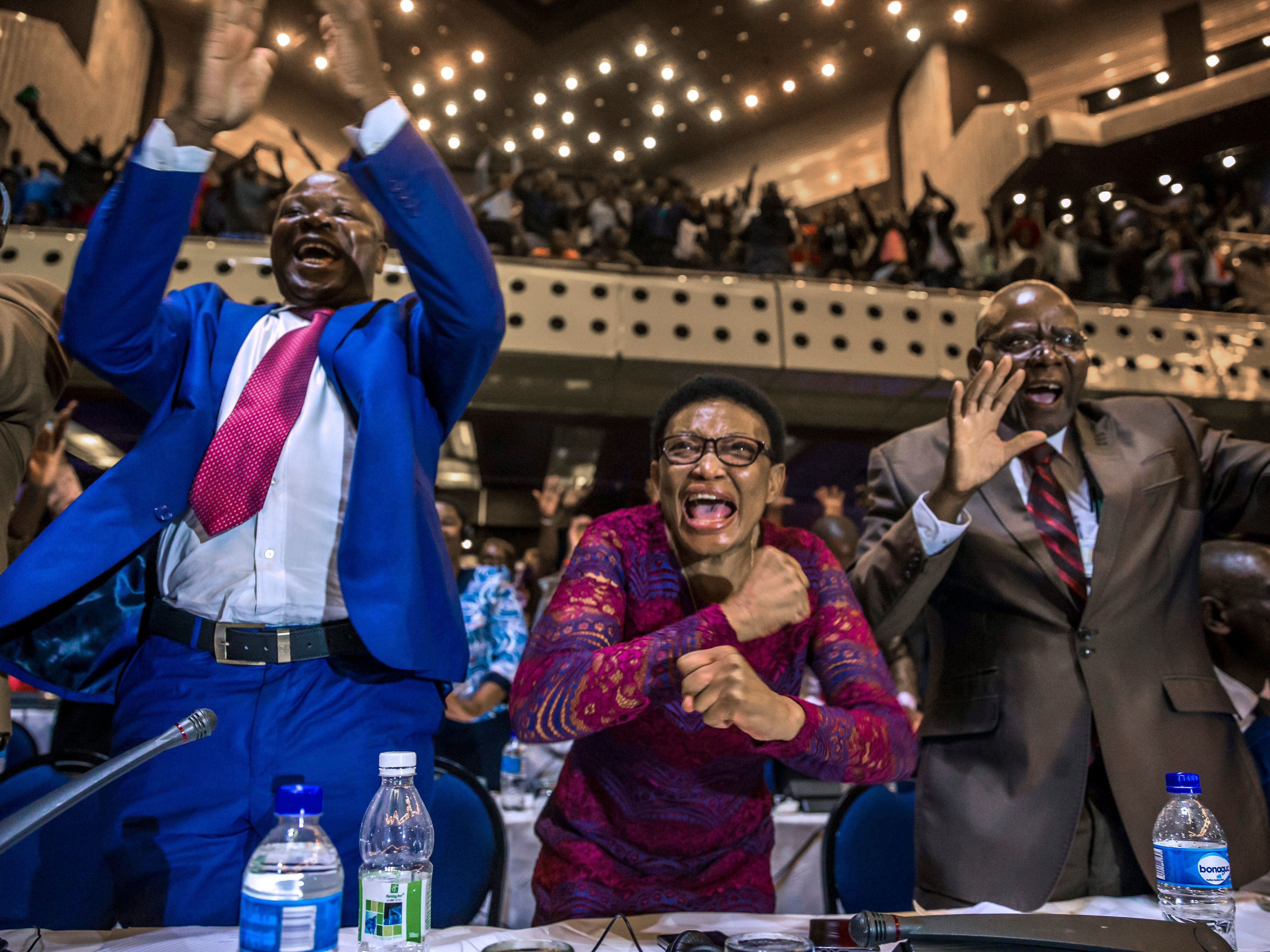 Members of Zimbabwe's parliament celebrate after receiving news of Mugabe's resignation on Tuesday. (AFP/Getty Images)