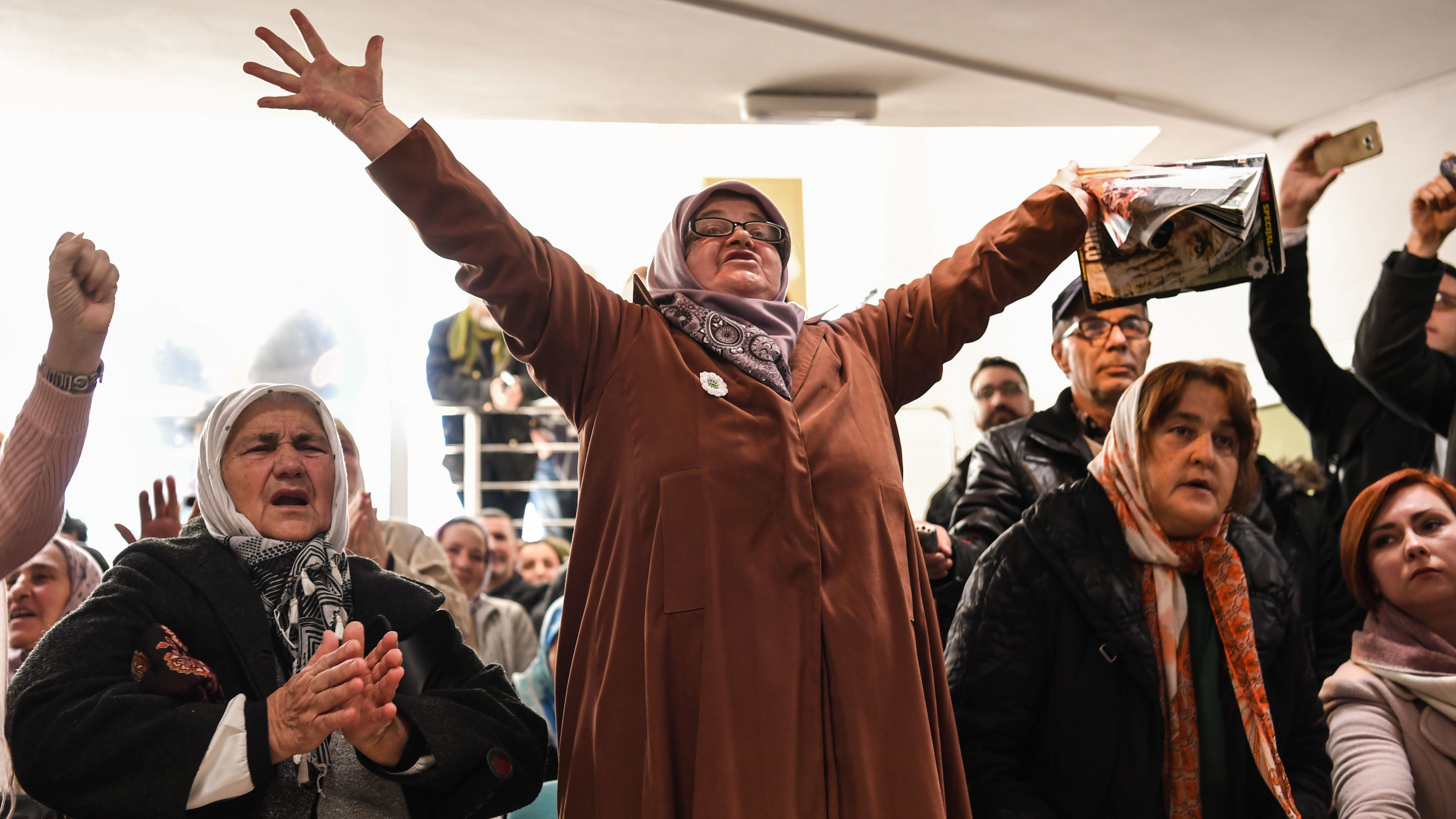 People celebrate as they watch a live TV broadcast on Wednesday in Srebrenica, when U.N. judges announce the life sentence in the trial of former Bosnian Serb commander Ratko Mladic, accused of genocide and war crimes in the brutal Balkans conflicts over two decades ago. (AFP/Getty Images)
