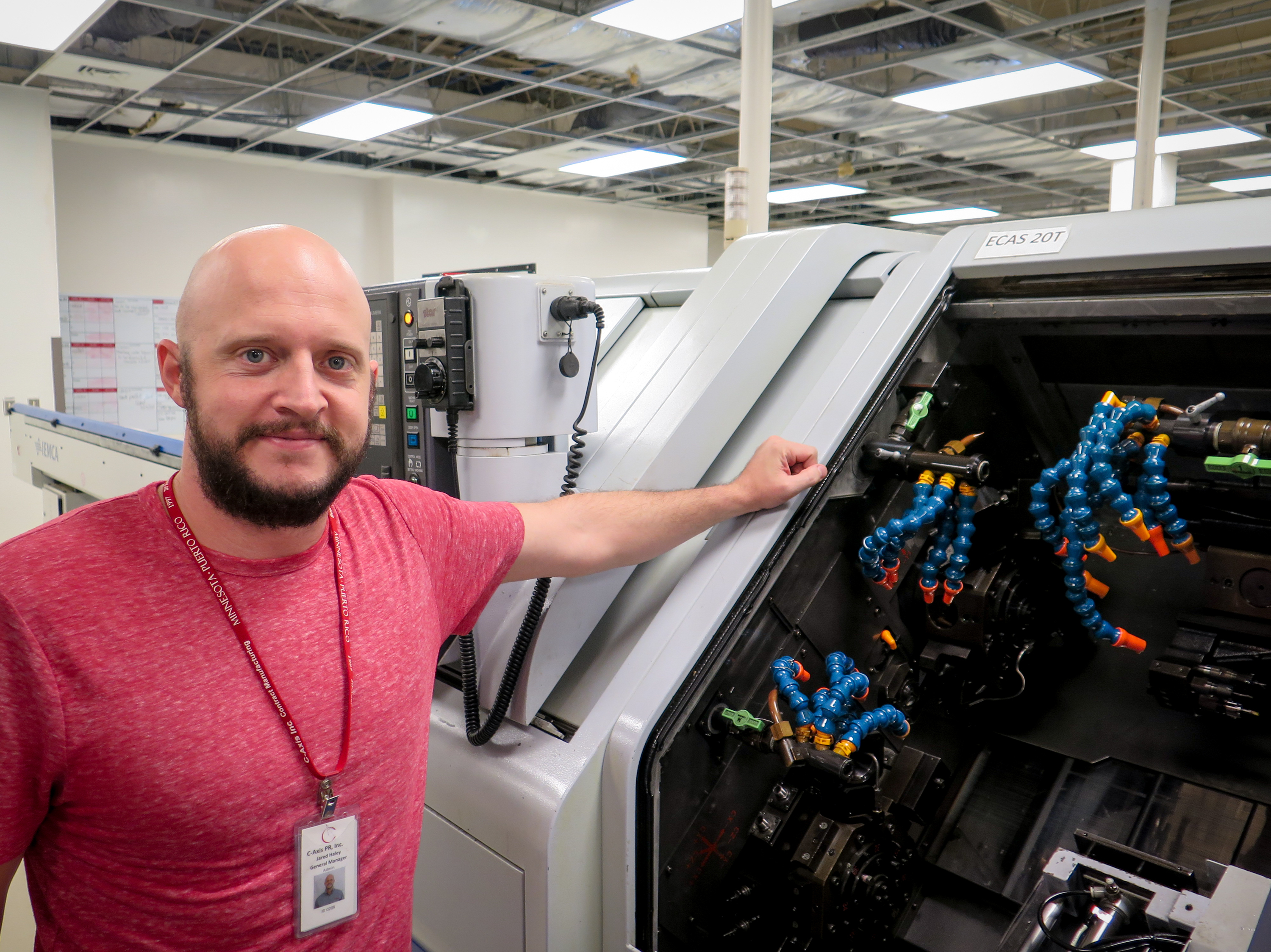 Jared Haley, general manager of the C-Axis plant in Caguas, Puerto Rico, says computer-operated milling machines like this one can cost more than a half-million dollars. Heat and humidity in the plant after Hurricane Maria left many of the machines inoperable, Haley says. (Greg Allen/NPR)