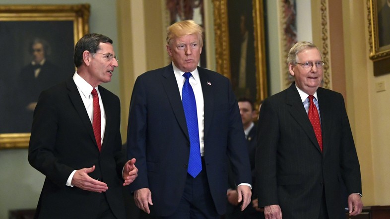 President Trump at a Senate GOP lunch with Sen. John Barrasso, R-Wyo. (left), and Senate Majority Leader Mitch McConnell, R-Ky., on Tuesday, where he talked with several holdouts on the tax bill about measures to bring them on board. (Susan Walsh/AP)