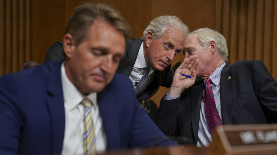 Sens. Jeff Flake, R-Ariz., Bob Corker, R-Tenn., and Ron Johnson, R-Wis., seen at a hearing earlier this month, held up floor action on Thursday evening over concerns about how to control the deficit if the GOP tax bill doesn't result in strong economic growth. (Pablo Martinez Monsivais/AP)