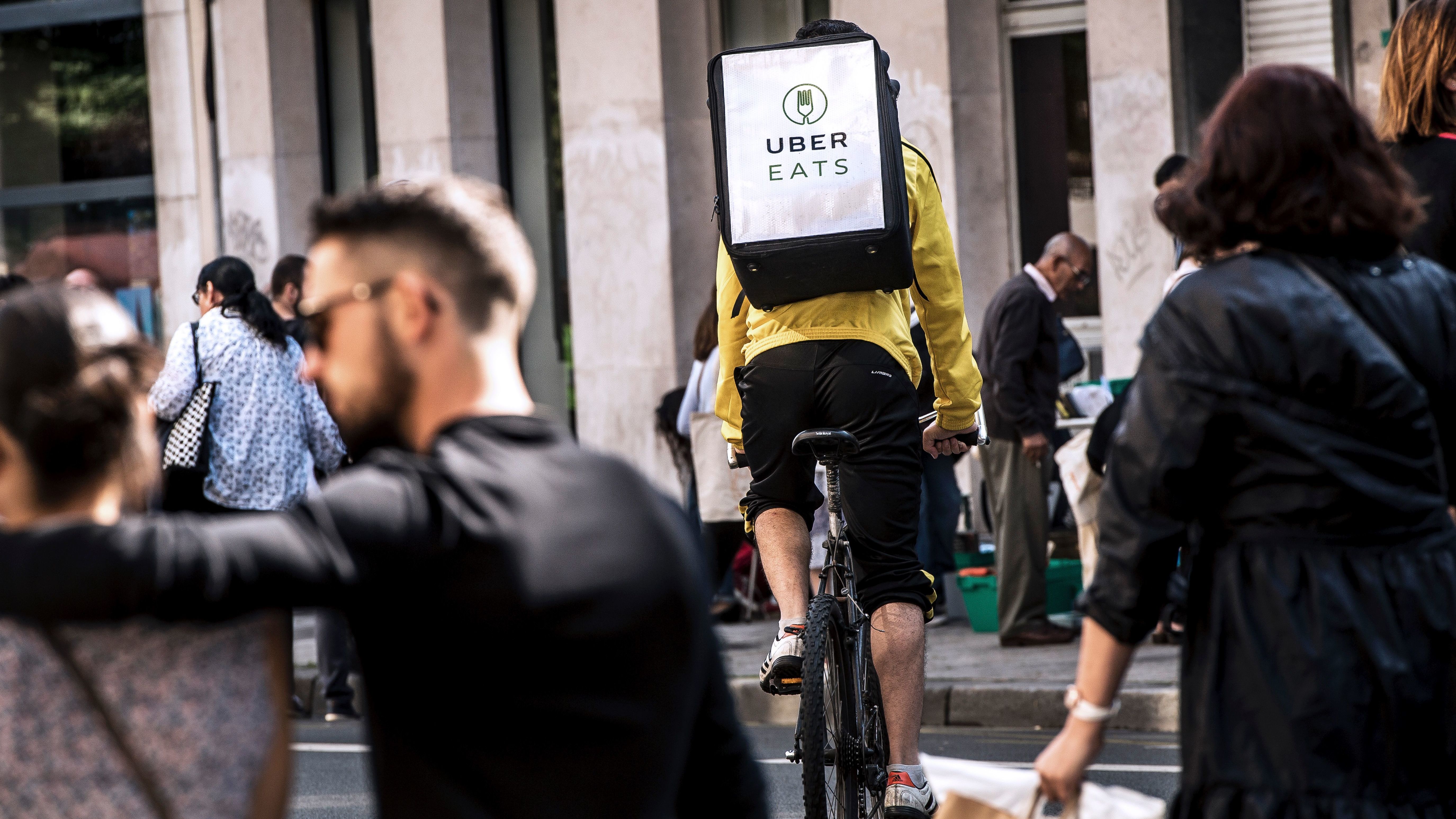 A cycle courier for meal delivery service Uber Eats rides past in Lille, France, on Sept. 2, 2017. In the U.S., advocates are raising concerns about the safety of workers in the gig economy. (AFP/Getty Images)