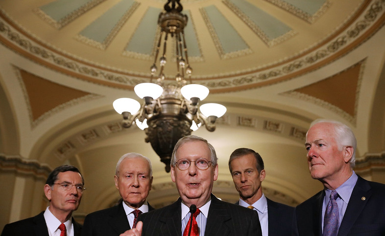 Senate Majority Leader Mitch McConnell, R-Ky. (center), gathered the support he needed on Friday to pass the GOP tax bill in the Senate. Now that legislation must be reconciled with the House version. (Chip Somodevilla/Getty Images)