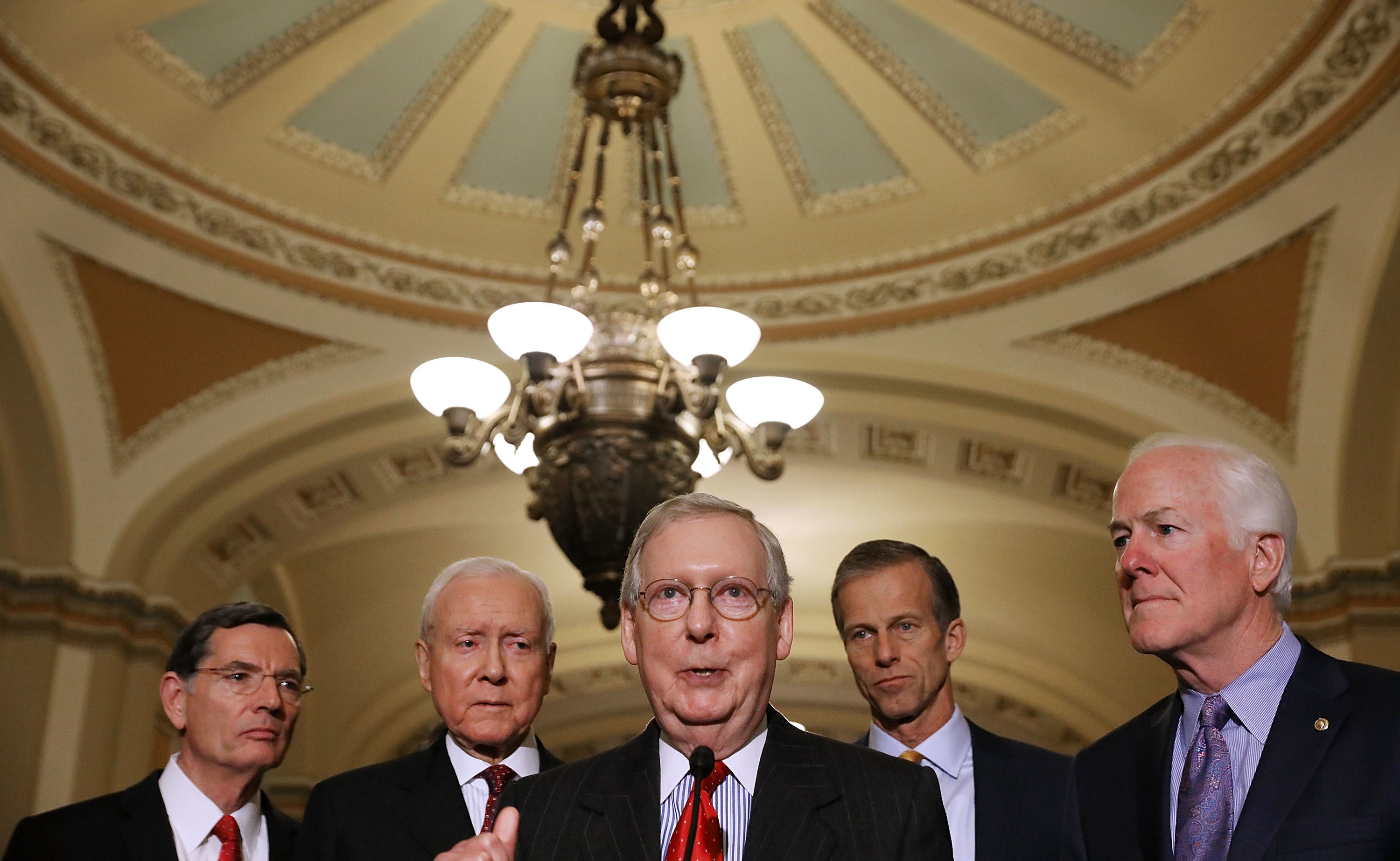 Senate Majority Leader Mitch McConnell, R-Ky. (center), gathered the support he needed on Friday to pass the GOP tax bill in the Senate. Now that legislation must be reconciled with the House version. (Getty Images)