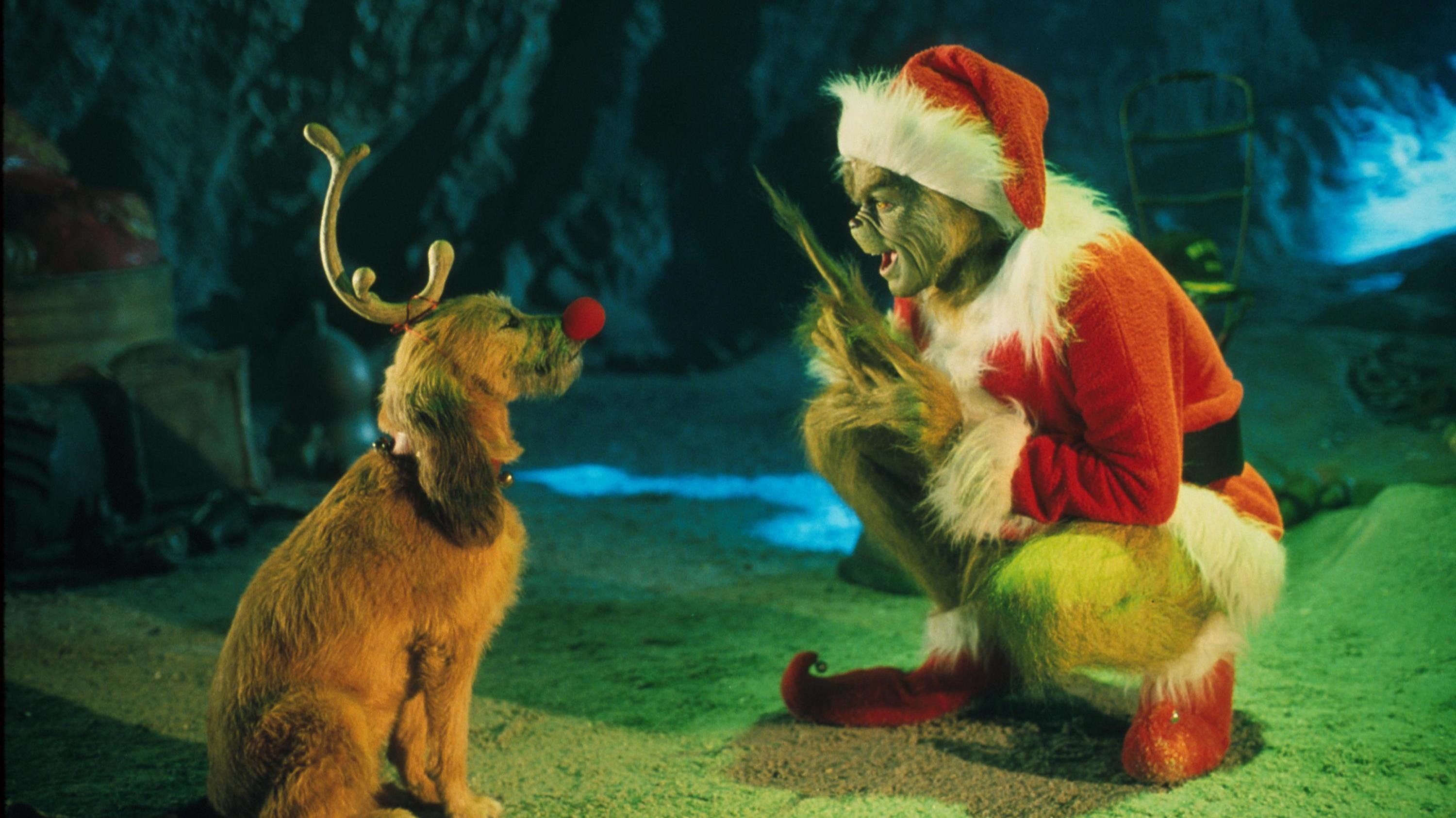 The Grinch, played by Jim Carrey, conspires with his dog Max to deprive the Whos of their favorite holiday in the live-action adaptation <em>Dr. Seuss' How The Grinch Stole Christmas</em>. (Getty Images)