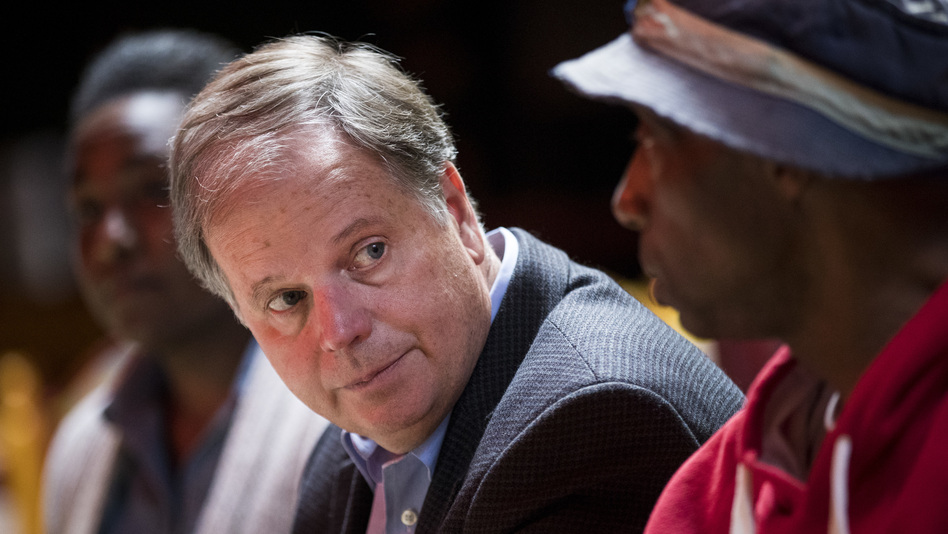 Democratic Senate candidate Doug Jones meets with supporters last month in Talladega, Ala. (Drew Angerer/Getty Images)