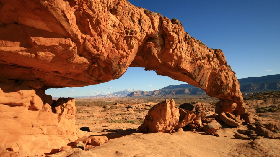 Sunset Arch rises from a sagebrush and slickrock flat in the Grand Staircase-Escalante National Monument in Utah. (Howard Berkes/NPR)