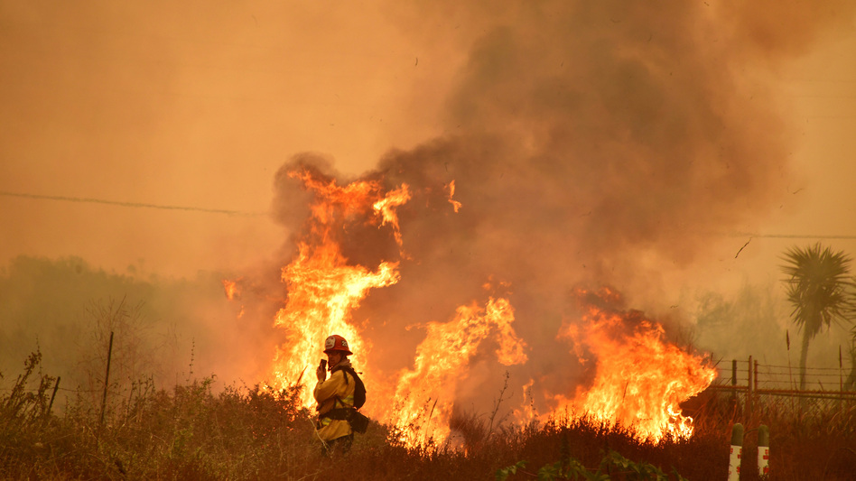 Fire and smoke rise off the northbound side of the U.S. 101 freeway in La Conchita, Ventura County. (Frederic J. Brown/AFP/Getty Images)