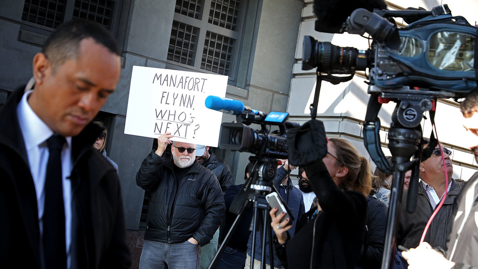Protesters outside the federal courthouse where Michael Flynn pleaded guilty early this month speculate what is coming next in the special counsel probe. (Chip Somodevilla/Getty Images)