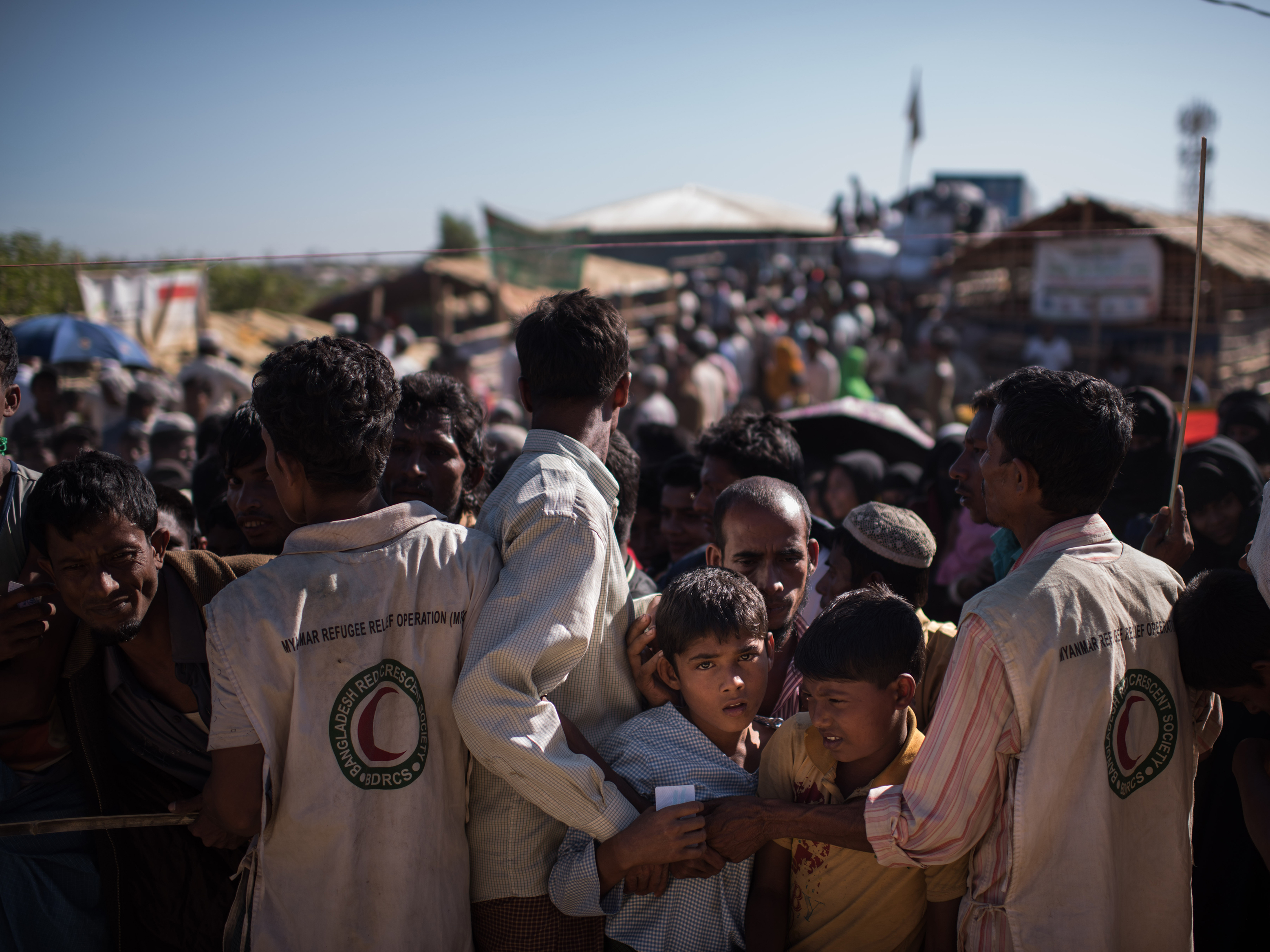 Rohingya Muslim refugee children queue for aid supplies at the Kutupalong refugee camp in Cox's Bazar on Dec. 4. Rohingya are still fleeing into Bangladesh even after an agreement was signed with Myanmar to repatriate hundreds of thousands of the Muslim minority displaced along the border, officials said Nov. 27. (AFP/Getty Images)