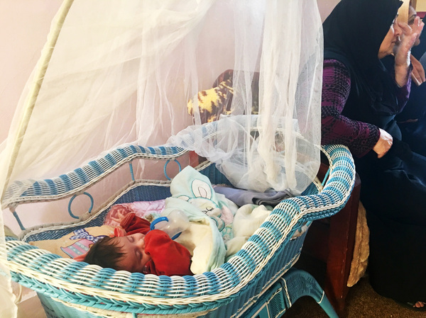 A 7-month-old injured after ISIS placed him in the street to use in an attack on Iraqi soldiers. Caregivers at the orphanage, to which NPR was given exclusive access, named him Hammoudi. His parents are unknown. He's one of the young children at a new orphanage in Mosul. The others are either orphaned, abandoned or rescued from kidnappers.