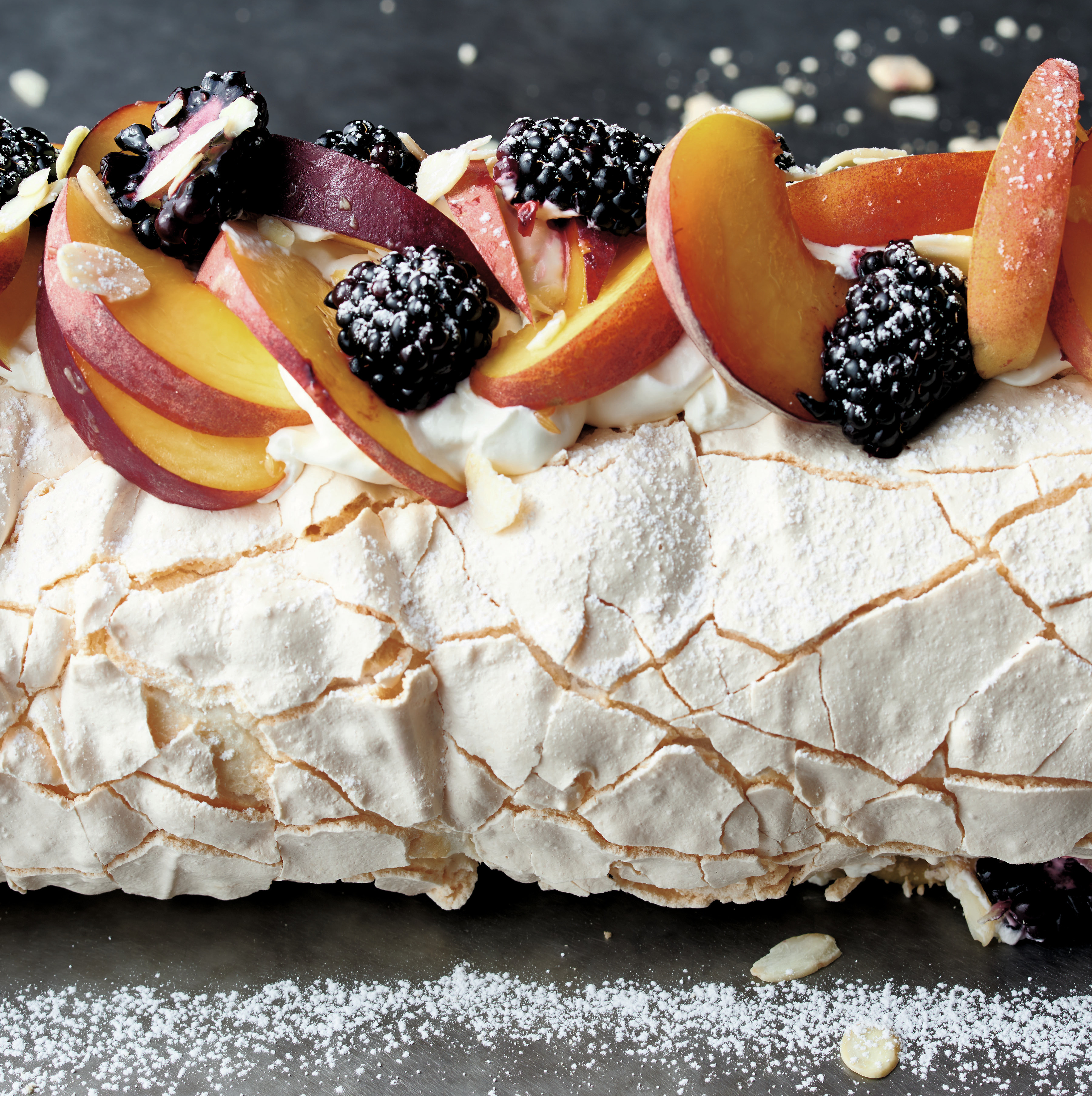 Pavlova is a meringue filled with cream and fruit. Chef Yotam Ottolenghi covers his with seasonal fruit. The version pictured above features summer peaches. For the holiday season, he suggests using plums and blackberries. (Peden + Munk)