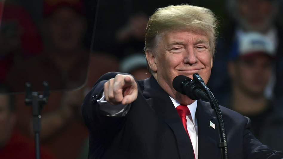 President Trump points out a supporter of Roy Moore, the embattled Alabama Republican Senate candidate, as he speaks at a campaign-style rally in Pensacola, Fla., Friday. (Susan Walsh/AP)