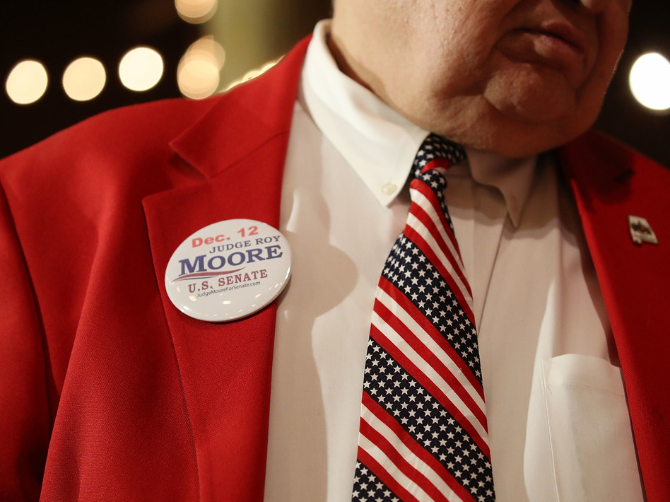 A supporter of Republican senatorial candidate Roy Moore attends a campaign rally at Oak Hollow Farm in Fairhope, Ala., on Dec. 5. Moore faces Democrat Doug Jones on Tuesday. (Joe Raedle/Getty Images)