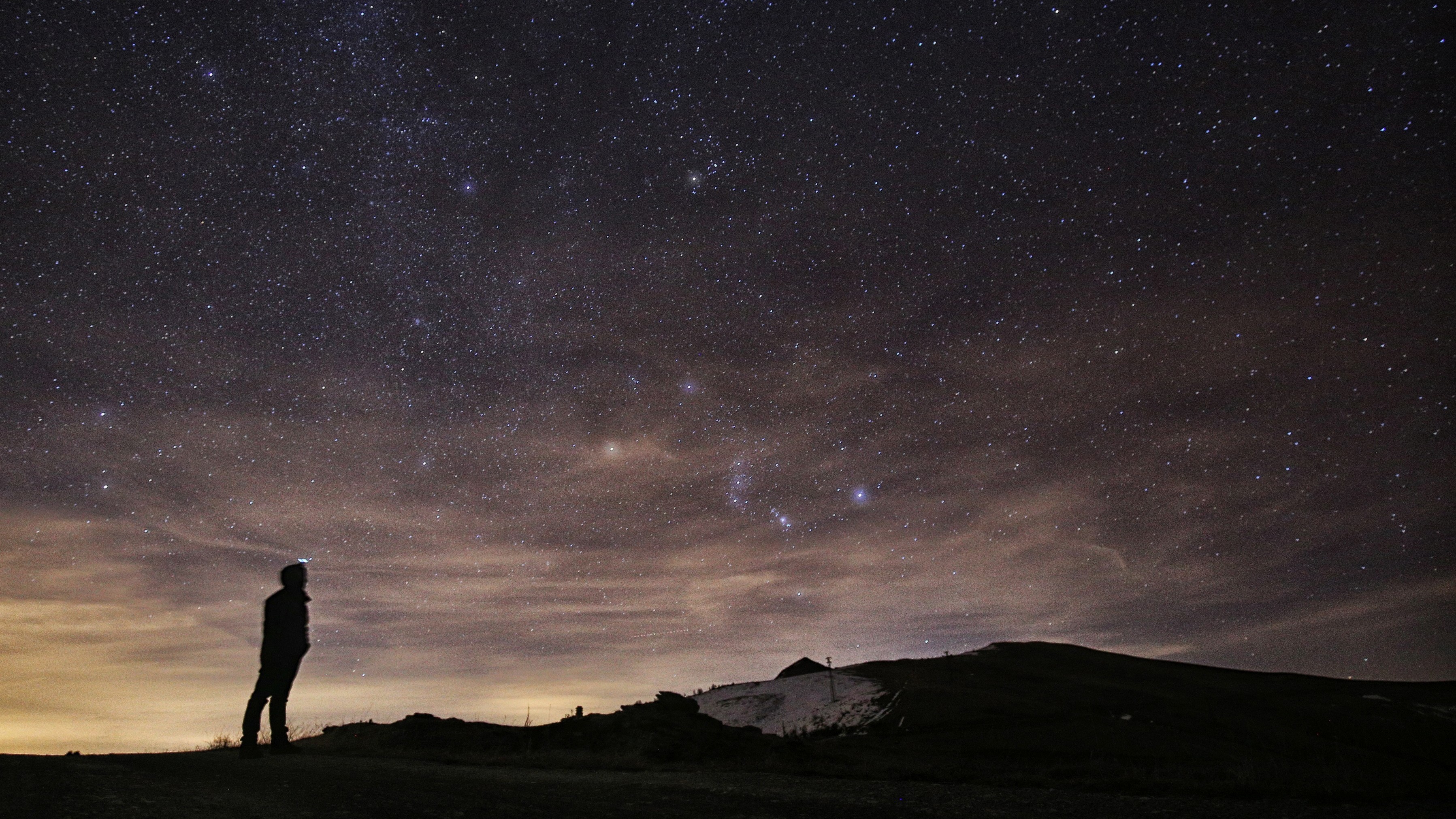 A photographer looks at the night sky to see the annual Geminid meteor shower in northern Italy in December 2015. This year