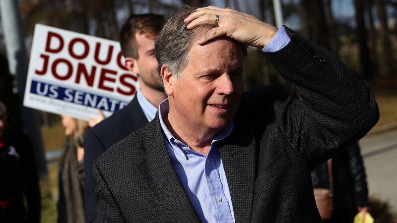 Alabama Democratic Senate Doug Jones prepares to greet voters outside a polling station in Bessemer, Ala., on Tuesday.
(Justin Sullivan/Getty Images)