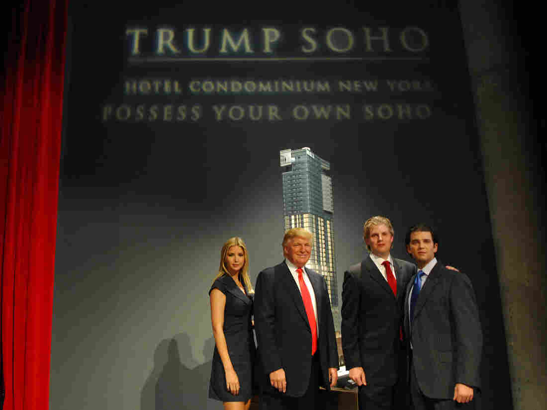 Ivanka Trump, Donald Trump, Eric Trump and Donald Trump Jr. stand before the rendering of the under-construction Trump SoHo Hotel Condominium in September 2007.
