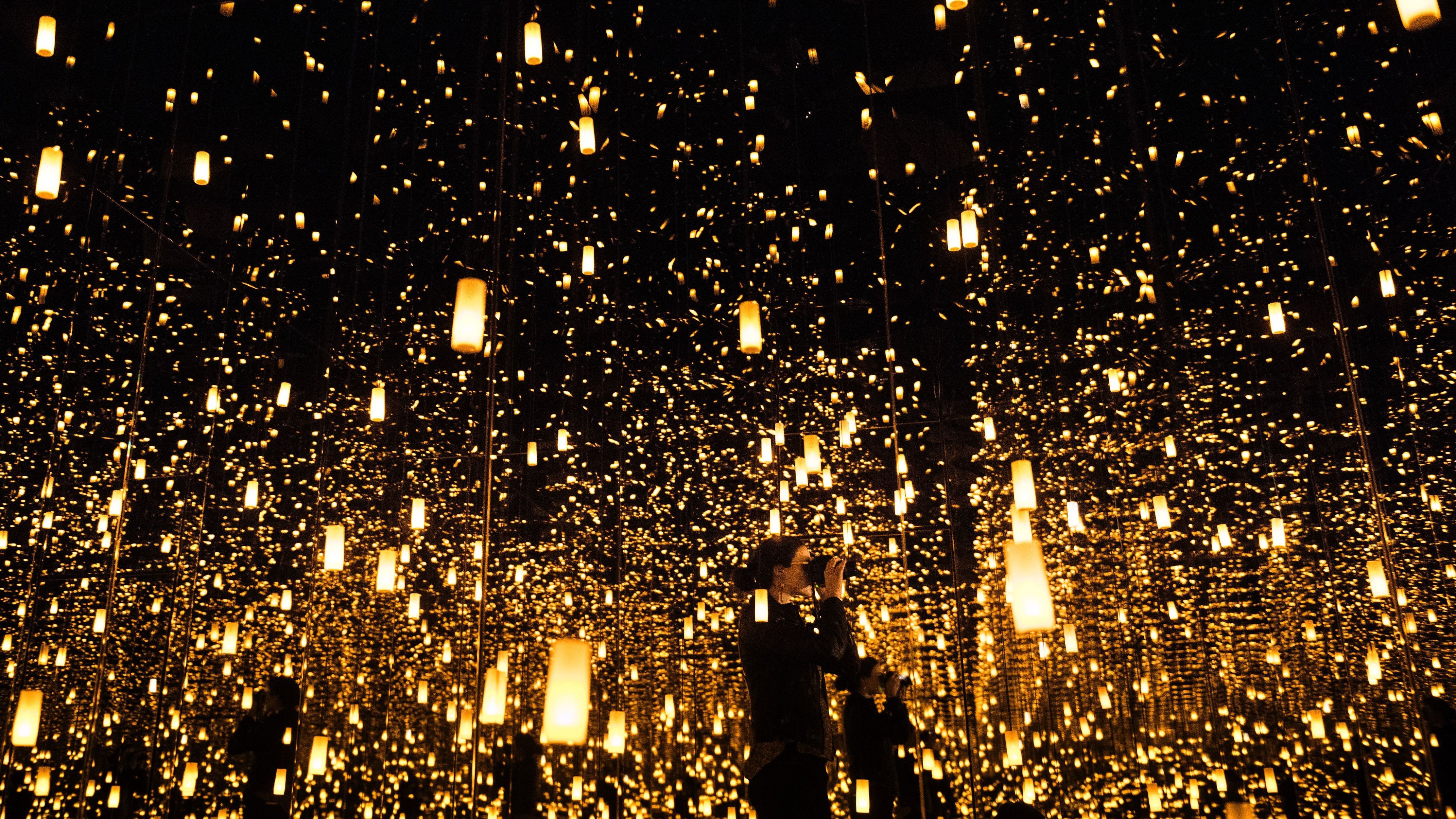 A woman photographs inside the &quot;Aftermath of Obliteration of Eternity&quot; room during a preview of the Yayoi Kusama's &quot;Infinity Mirrors&quot; exhibit at the Hirshhorn Museum on Feb. 21, 2017 in Washington, D.C. (AFP/Getty Images)