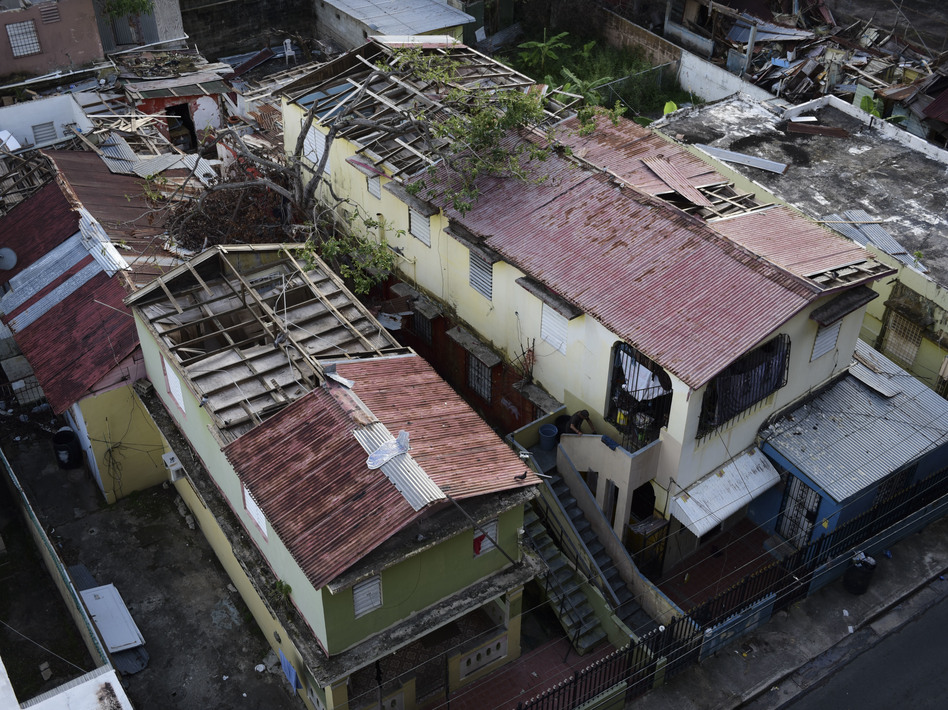 This photo taken last month in San Juan, Puerto Rico, shows roofs damaged by Hurricane Maria and the interior of buildings still exposed to the elements. (Carlos Giusti/AP)