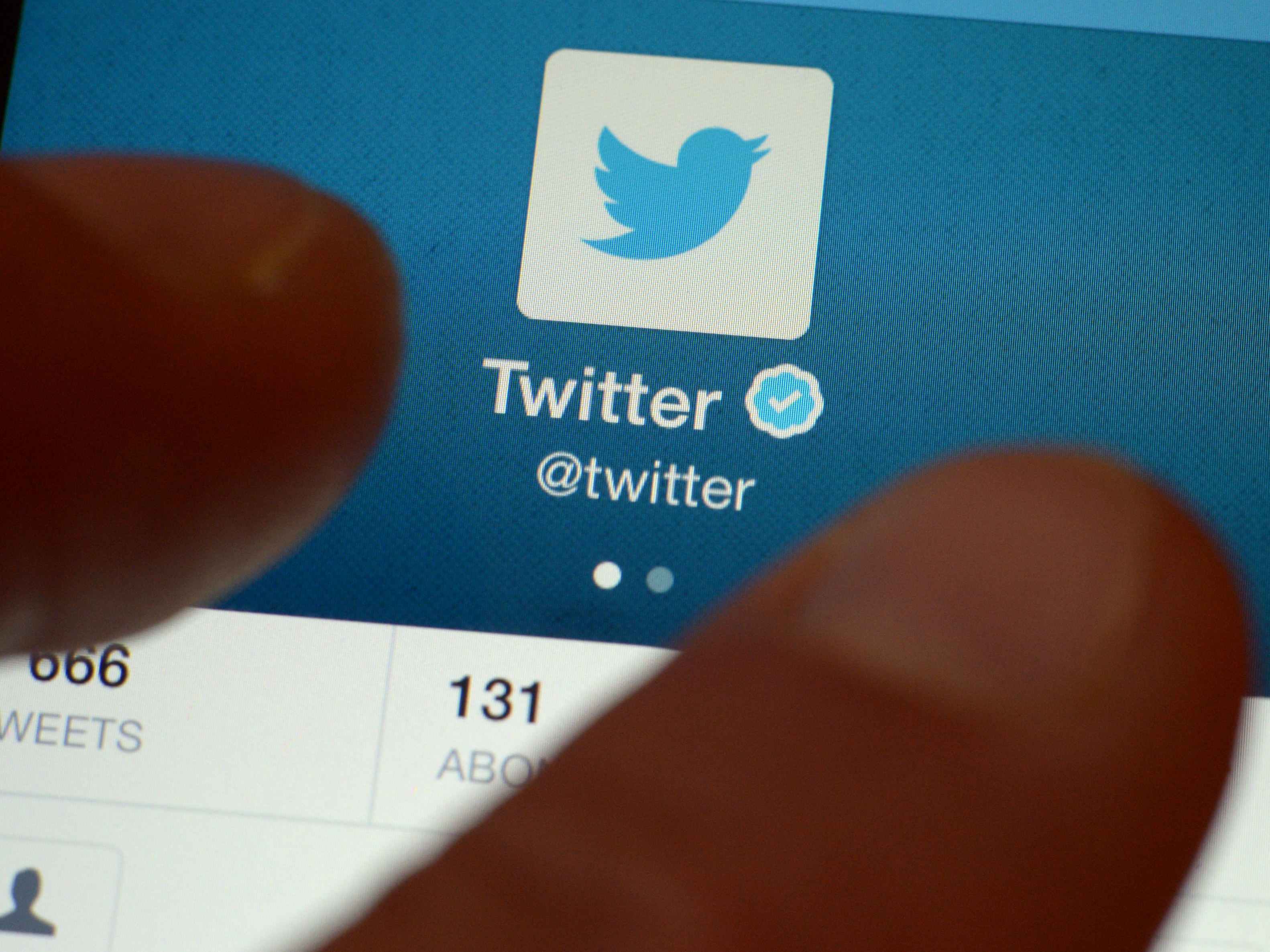 Twitter's official account on a smartphone. The platform has announced it will enforce a new set of rules aiming to curb abuse and harassment. (AFP/Getty Images)