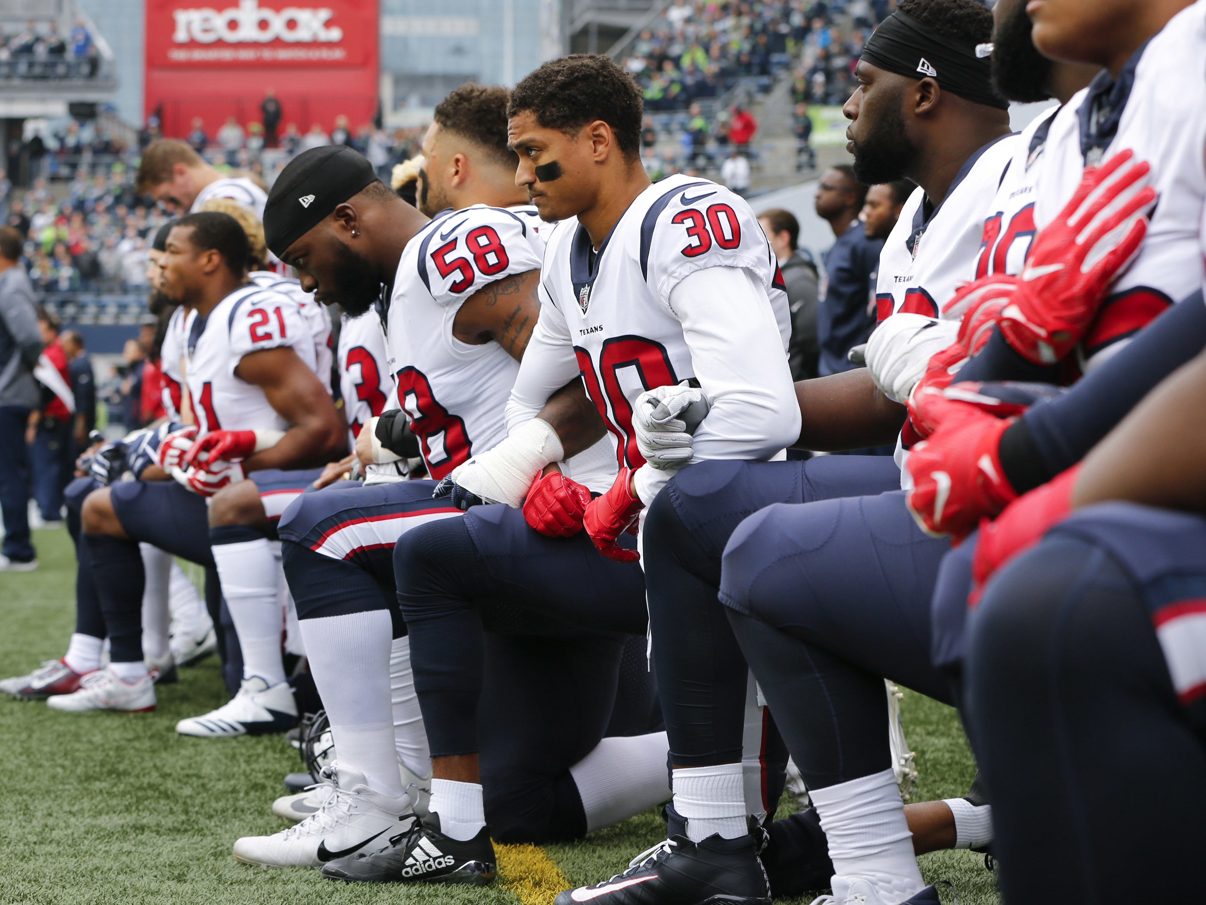 Members of the Houston Texans kneel during the national anthem before the game at CenturyLink Field on Oct. 29, 2017 in Seattle. (Getty Images)