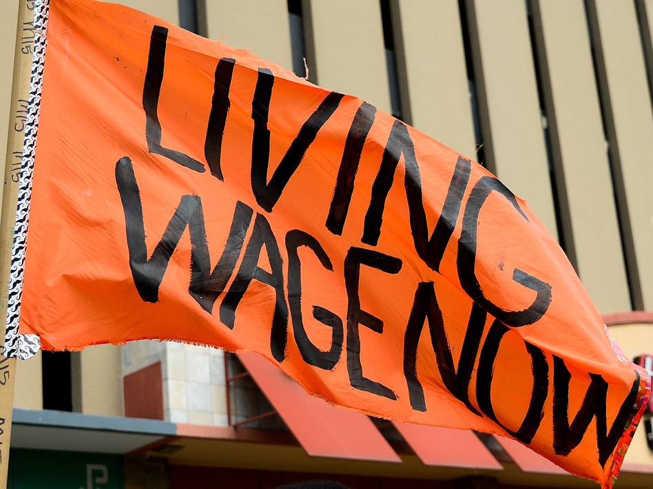 Protesters rally outside a restaurant in St. Louis on Feb. 13. The service industry employs the largest percentage of minimum wage workers. (Jeff Curry/Getty Images)