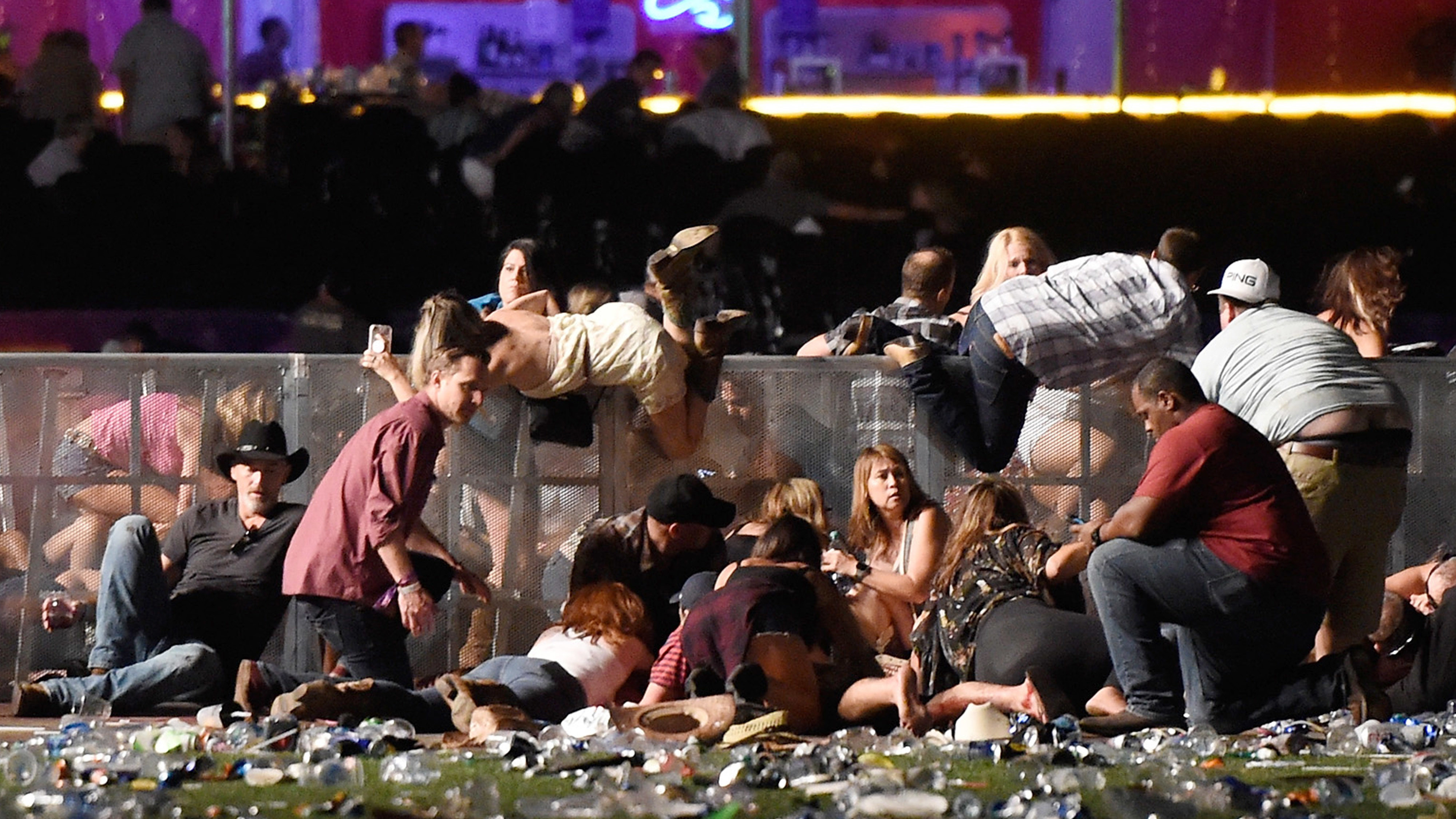 People scramble for shelter at the Route 91 Harvest country music festival in Las Vegas after gunfire was heard. (David Becker/Getty Images)