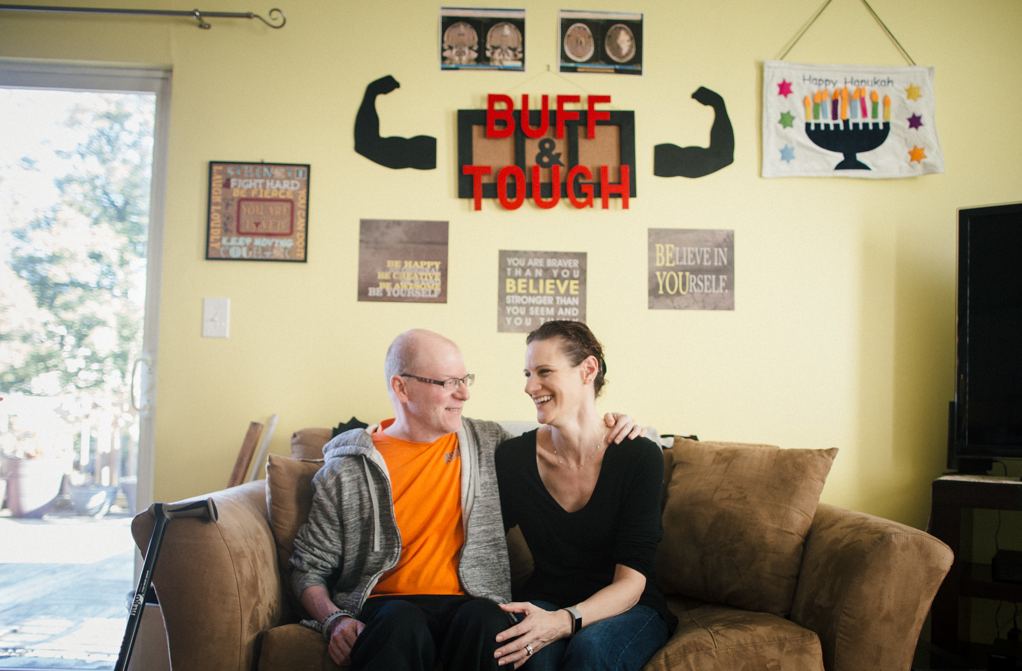 Ben and Tara Stern relax at home in Essex, Md. Ben was diagnosed with glioblastoma in 2016. After conventional treatment failed to stop the tumor, Ben tried an experimental drug. (Meredith Rizzo/NPR)