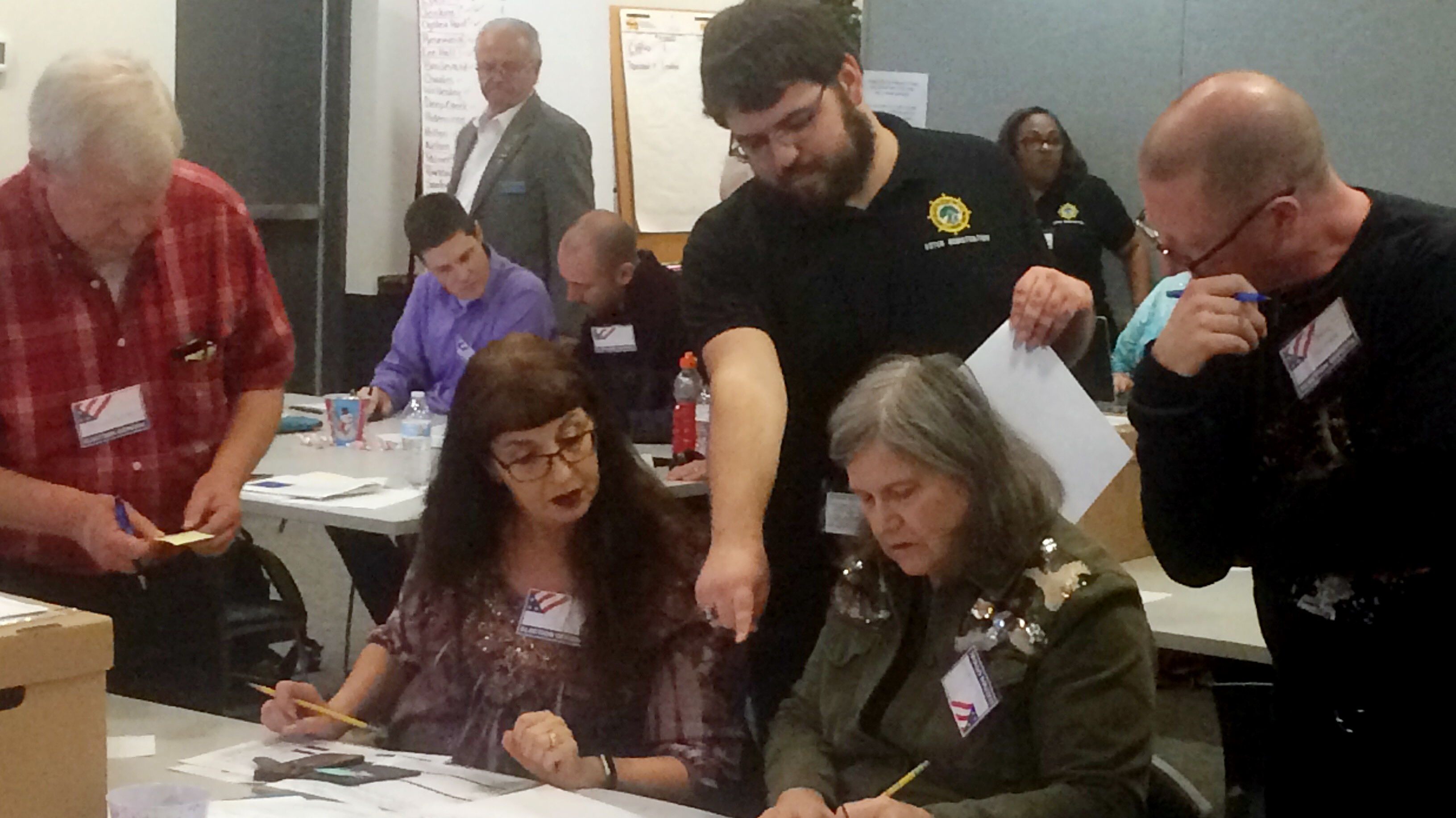 The result of the race between Republican incumbent David Yancey and Democratic challenger Shelly Simonds is still in doubt. Here, election officials in Newport News, Va., examine ballots that a computer failed to scan during a Dec. 19 recount for their House of Delegates race.