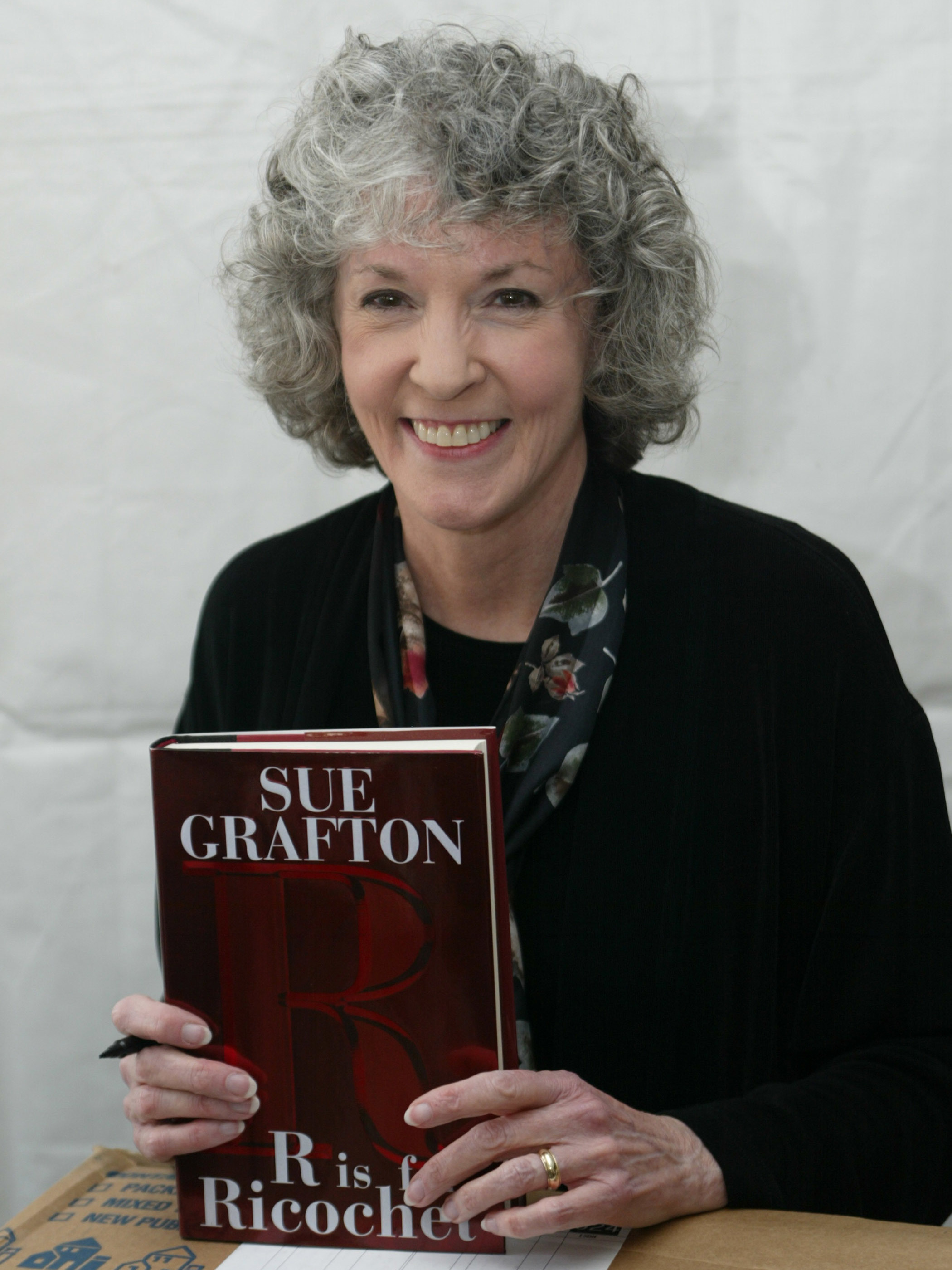 Author Sue Grafton, author of 25 mysteries featuring detective Kinsey Millhone, died Thursday at age 77. Grafton is seen here with a copy of her book <em>R is for Ricochet</em> in 2005. (Getty Images)