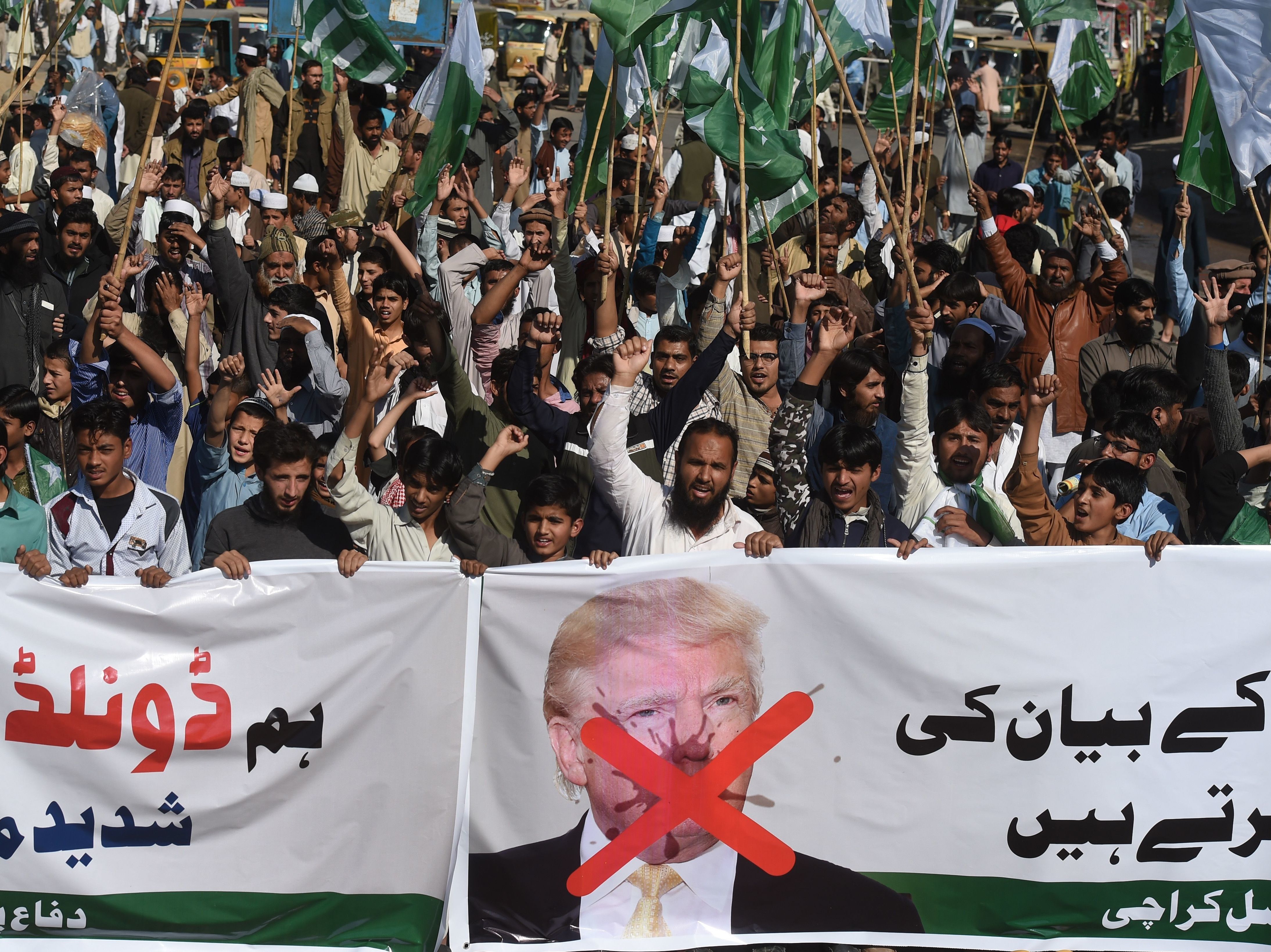 Activists of the Difa-e-Pakistan Council shout anti-U.S. slogans at a protest in Karachi on Tuesday. Pakistan summoned the U.S. ambassador after President Trump lashed out at Islamabad with threats to cut aid over &quot;lies&quot; about militancy. (AFP/Getty Images)