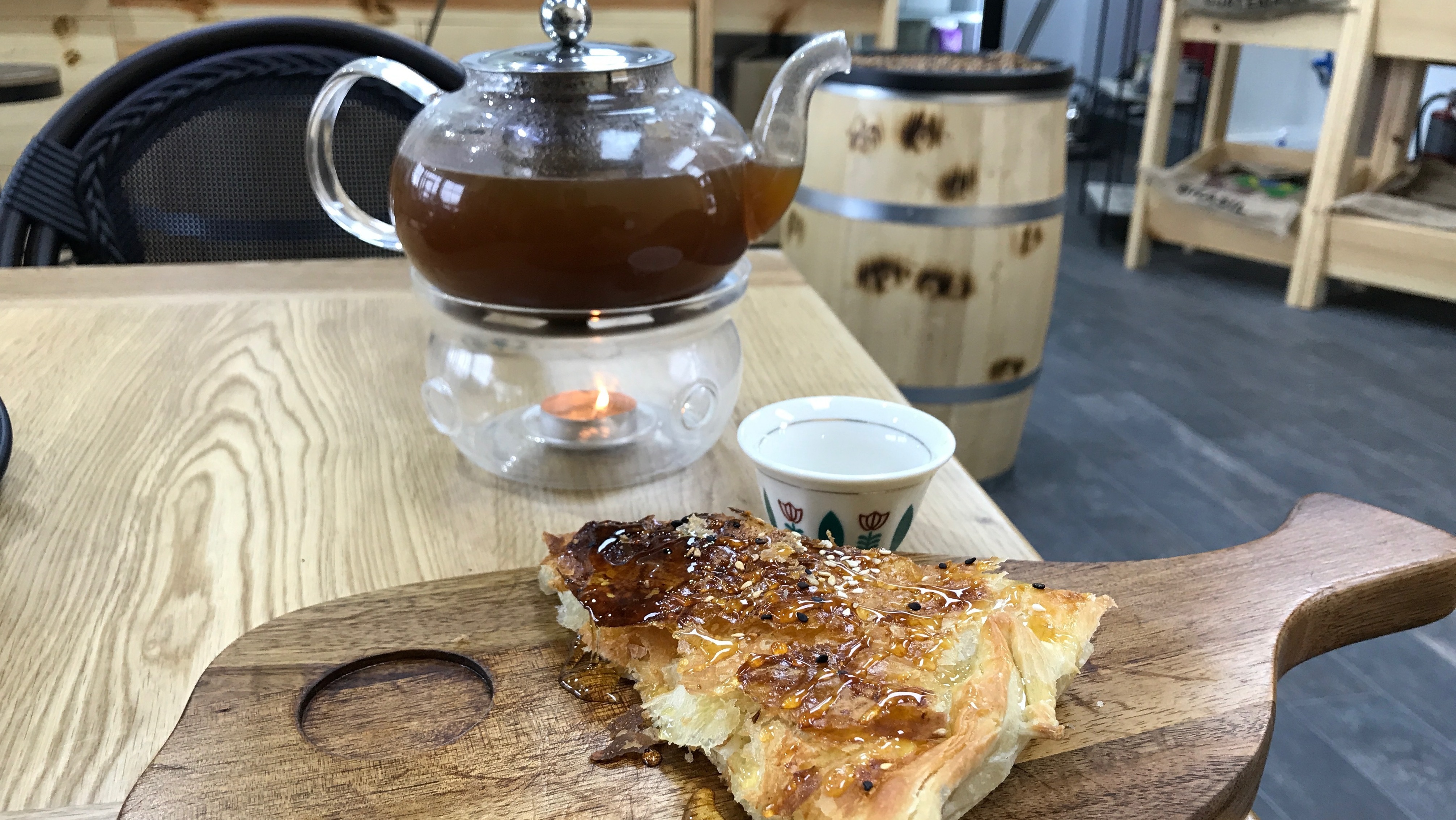 A traditional pot of Yemeni coffee, mixed with cardamom and ginger, is served with a Yemeni sweet honey bread at a new Yemeni coffee shop in Dearborn, Mich. Owner Ibrahim Alhasbani sees himself as part entrepreneur, part cultural ambassador for his home country. (Zahir Janmohamed)