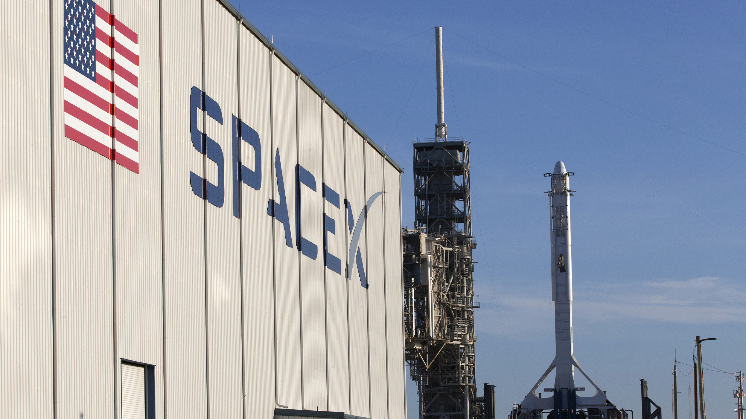 A SpaceX Falcon 9 rocket and Dragon spacecraft await liftoff from the Kennedy Space Center