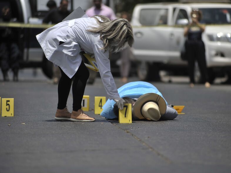 Mexican journalist Javier Valdez lies on the street after he was shot dead in Sinaloa, Mexico, on May 15, 2017. The U.S. State Department is telling Americans to completely avoid five Mexican states because of rising crime and violence. (FERNANDO BRITO/AFP/Getty Images)