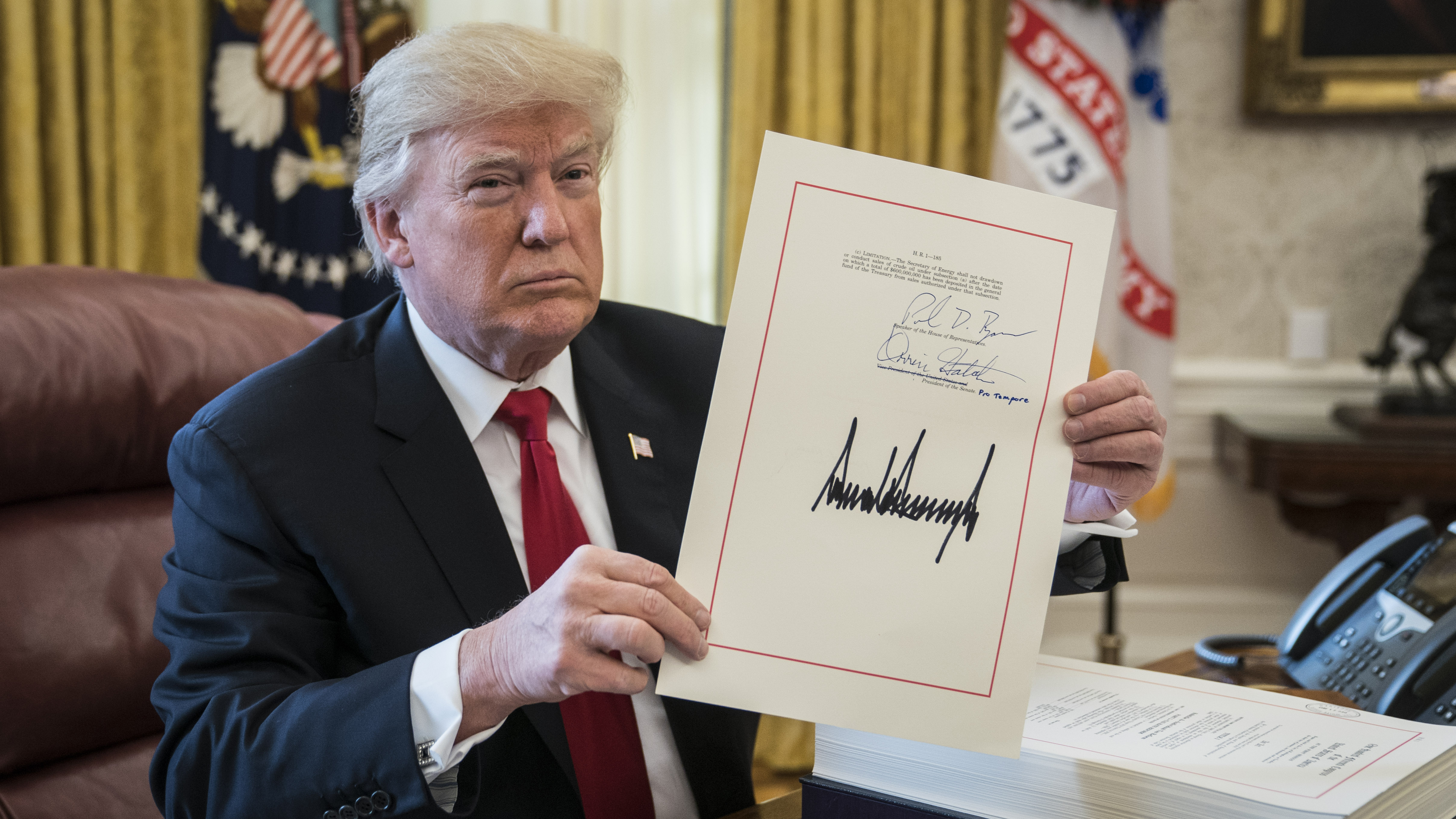 President Trump signs the $1.5 trillion tax overhaul package into law on Dec. 22. (The Washington Post/Getty Images)