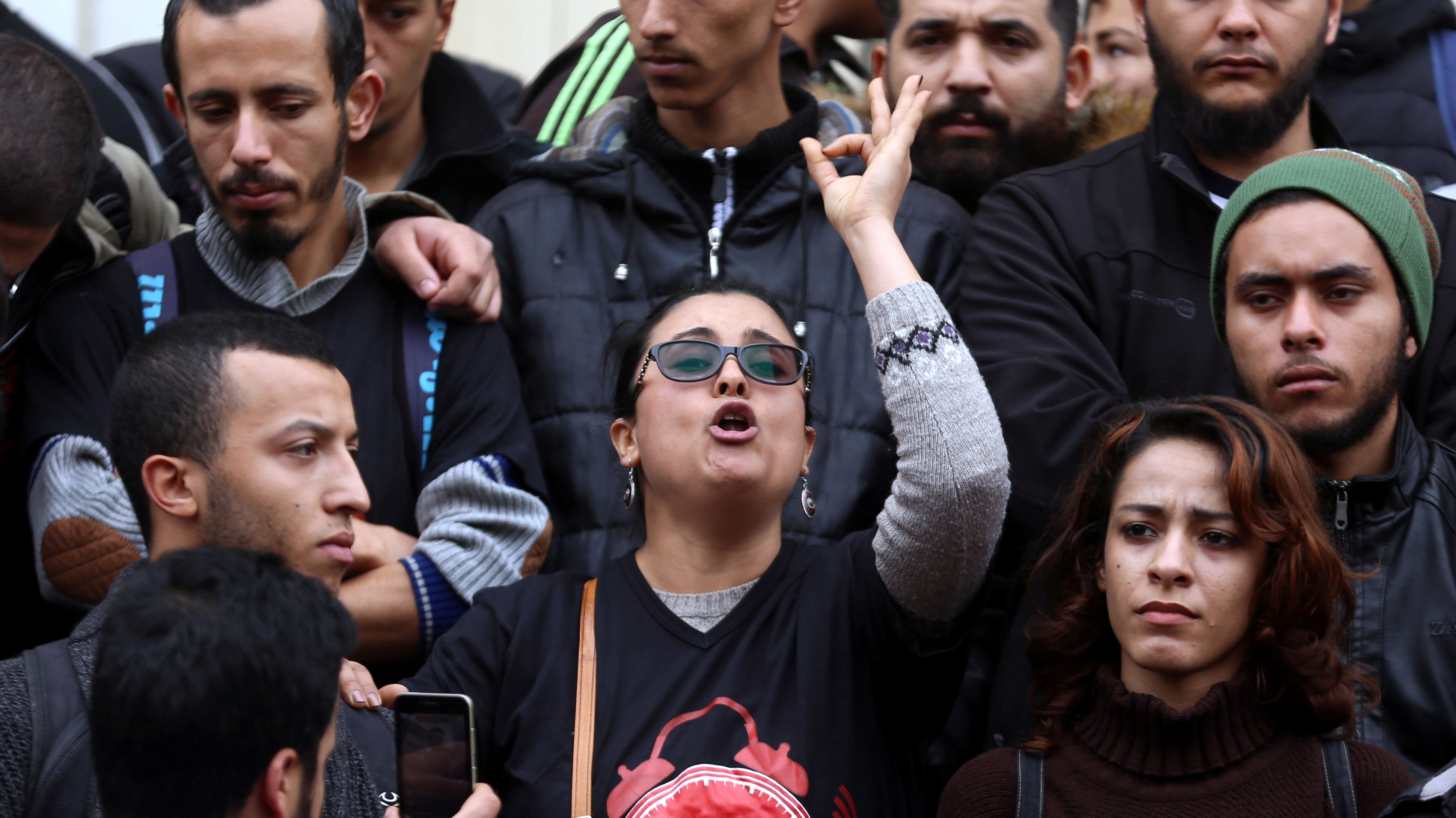 A demonstrating graduate shouts slogans during protests against rising prices and tax increases in Tunis on Tuesday