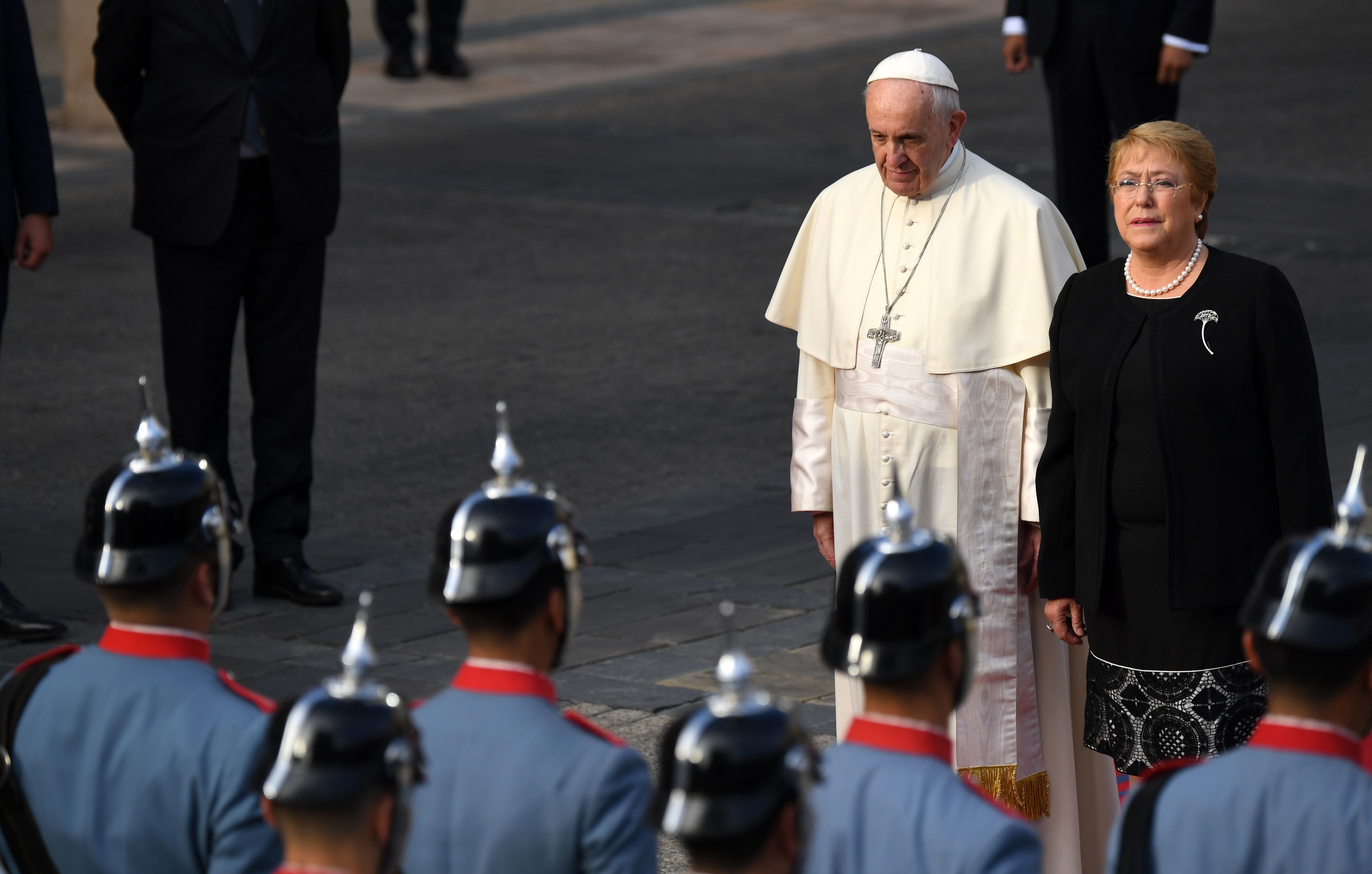 Pope Francis is welcomed by Chile's President Michelle Bachelet at La Moneda Presidential Palace in Santiago on Tuesday. The pope landed in Santiago late Monday on his first visit to Chile since becoming pope, and his sixth to Latin America — a trip that will also take him to Peru. (AFP/Getty Images)