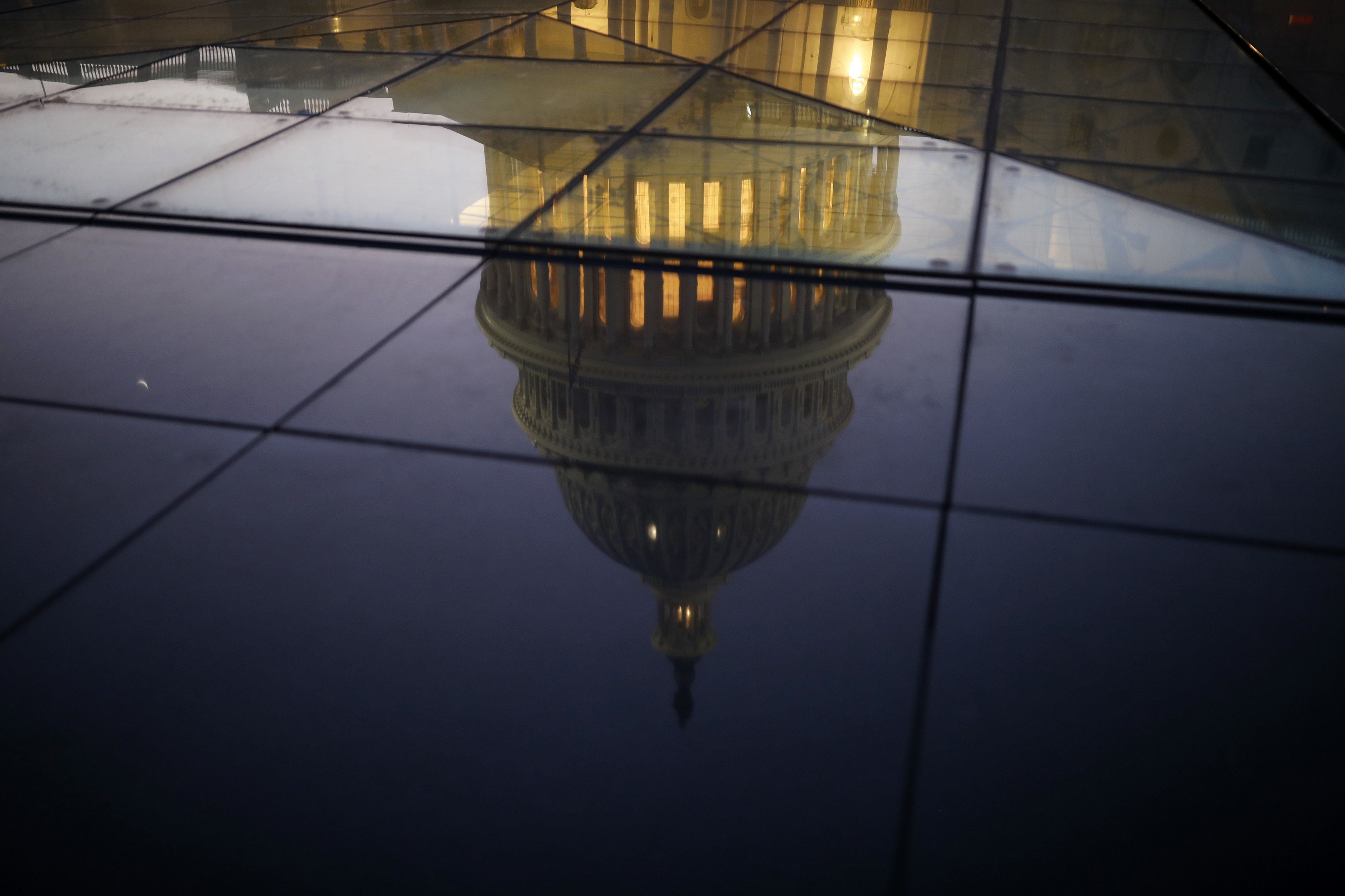 The U.S. Capitol is seen reflected in the windows of the Capitol Visitors Center as lawmakers debated ahead of the government shutdown on Jan. 19. (Getty Images)