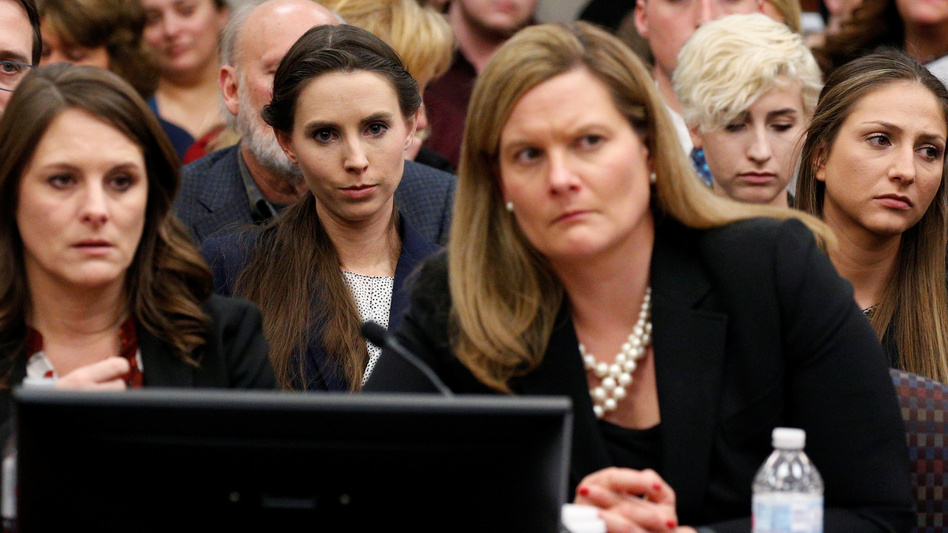 The entire USA Gymnastics board will resign, the group says. Rachael Denhollander (center) listens as Larry Nassar, a former team USA Gymnastics doctor, was sentenced to up to 175 years in prison for sexual abuse over decades of his involvement with the program. (Brendan McDermid/Reuters)