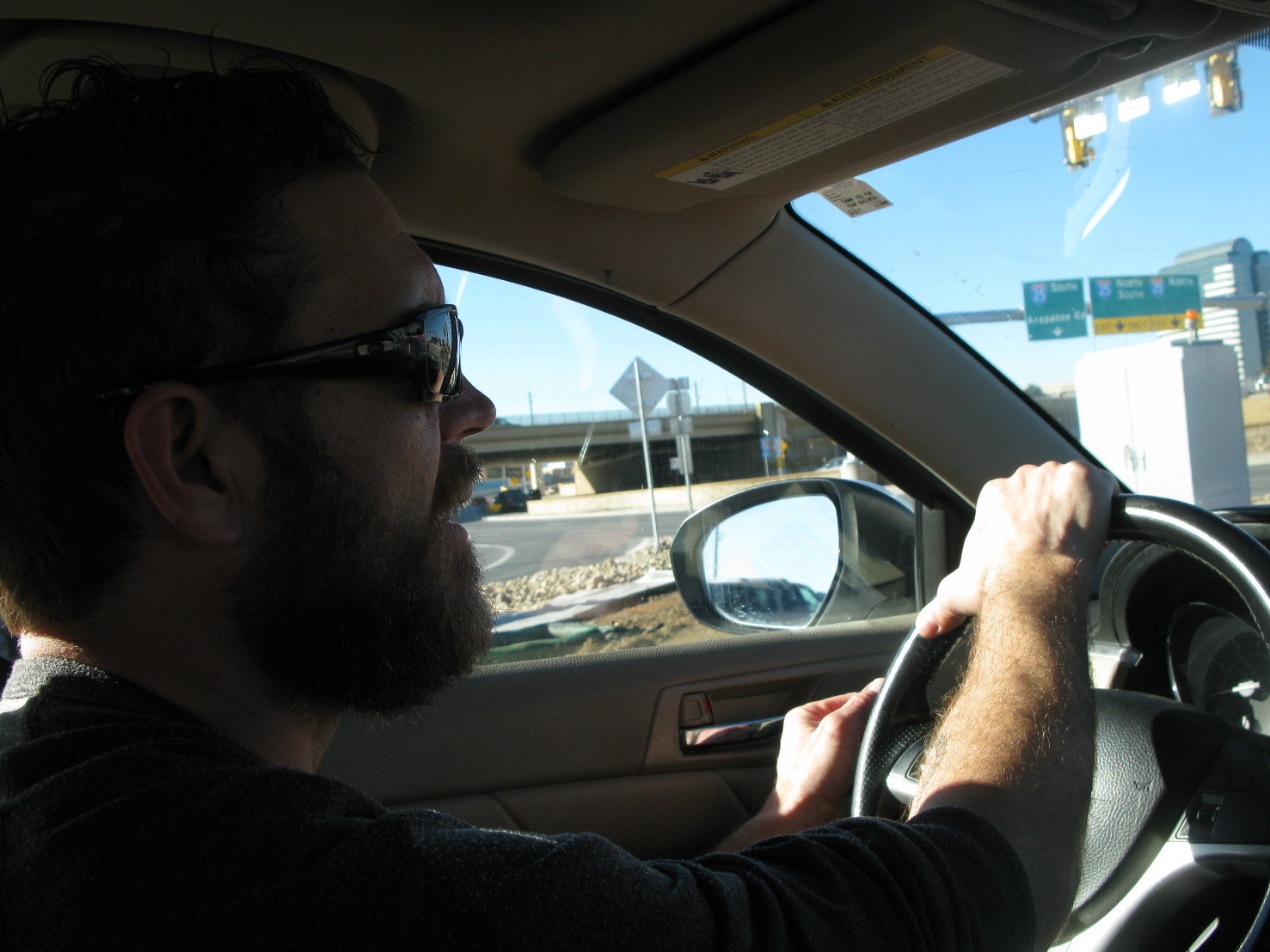 Tom Hansen sometimes turns to driving for Lyft to make extra money because his restaurant job has irregular hours and pay. (NPR)