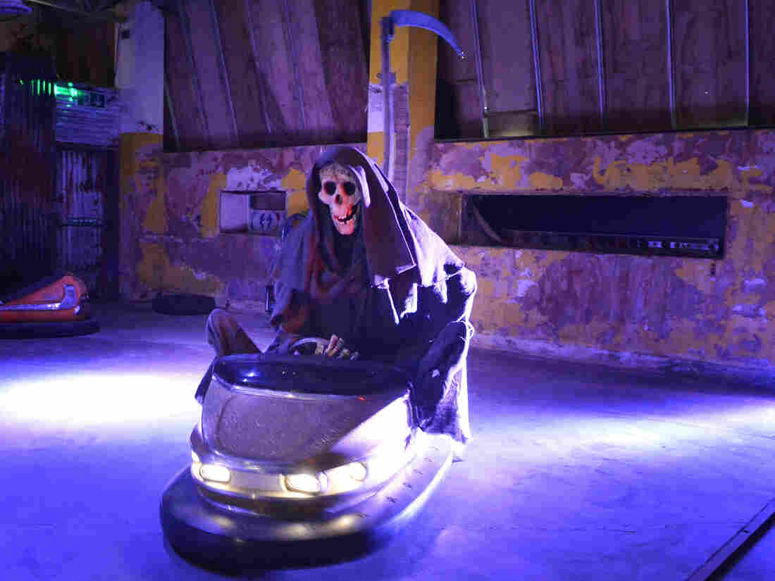 The Grim Reaper rides a bumper car.