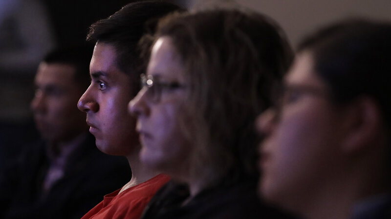 Victor Guzman, an undocumented resident, watches President Donald Trump speak during a State of the Union watch party Tuesday in Chicago. (Charles Rex Arbogast/AP)