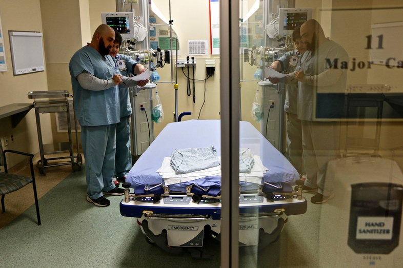 A doctor and nurse confer inside a room used for flu patients at Northside Hospital in Cumming, Ga. The U.S. government's latest flu report, released Friday, showed flu season continued to intensify, with high volumes of flu-related patient traffic in 42 states, up from 39 the week before. (Robert Ray/AP)