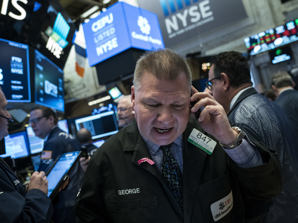 Traders at the New York Stock Exchange on Friday. The Dow Jones industrial average fell 666 points amid signs that interest rates are heading higher. (Drew Angerer/Getty Images)