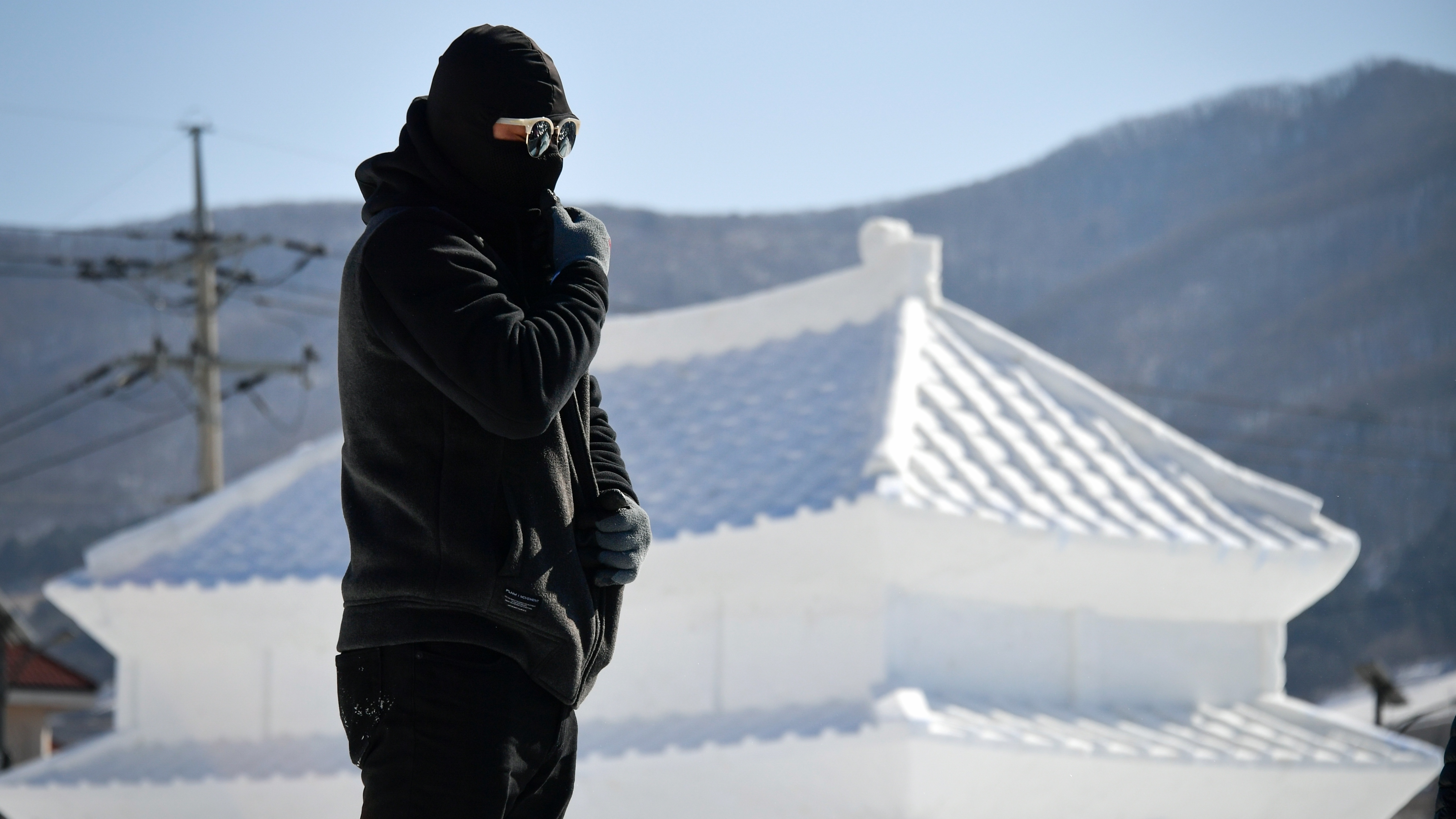 The Pyeongchang 2018 Winter Olympics reverse a recent trend of relatively warm conditions at the Winter Games. Here, a man prepares to work in front of an ice sculpture ahead of Friday's opening ceremony. (AFP/Getty Images)
