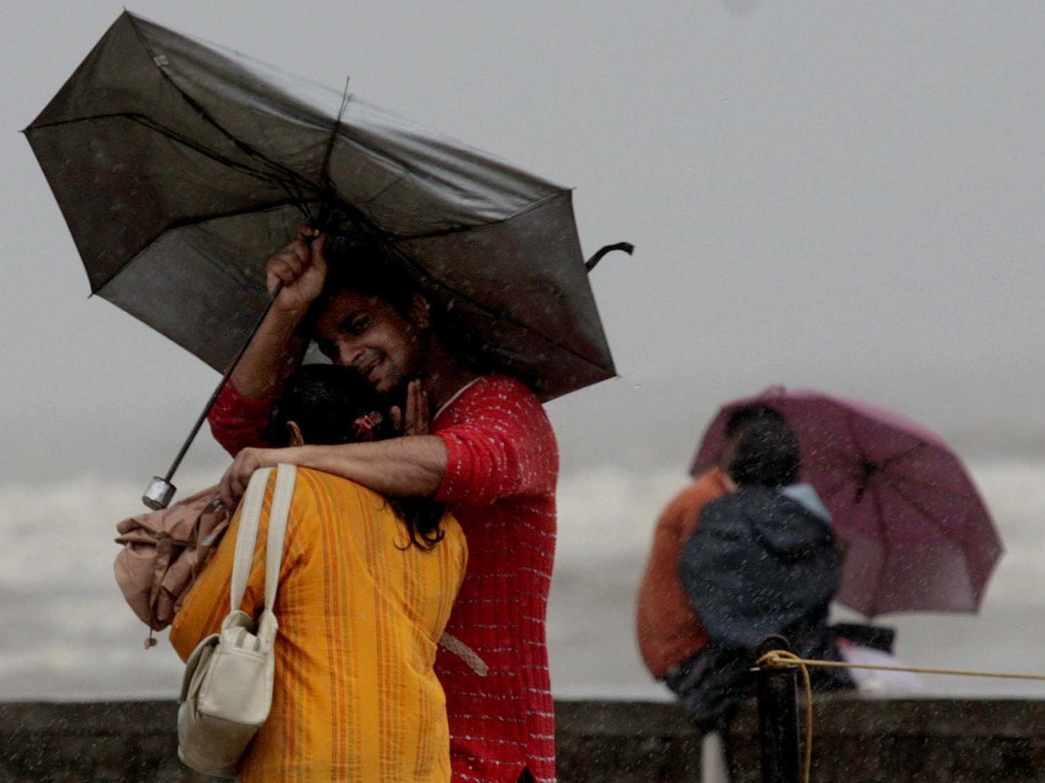A couple walks in the rain in Mumbai in 2007. (Hindustan Times via Getty Images)