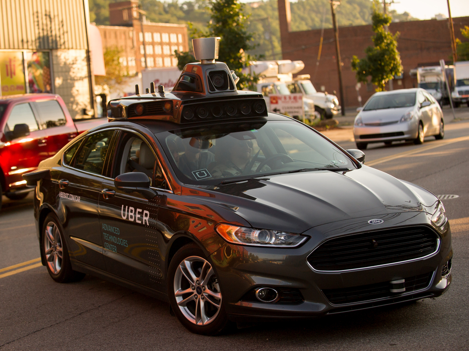An Uber driverless Ford Fusion drives in Pittsburgh in 2016. On Friday, Uber and Google's Waymo self-driving unit announced a settlement in their trade secrets case. (Jeff Swensen/Getty Images)
