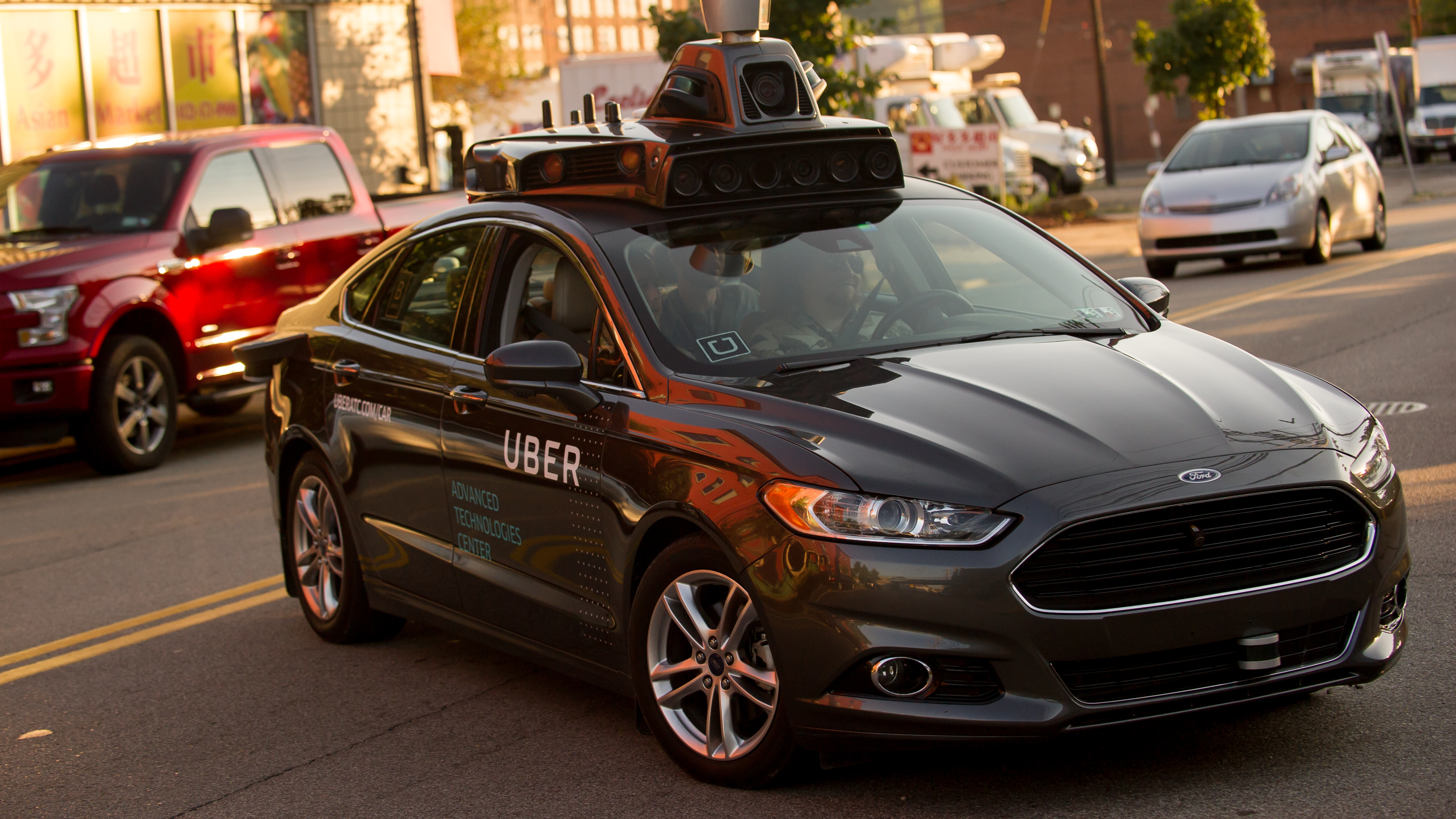 An Uber driverless Ford Fusion drives in Pittsburgh in 2016. On Friday, Uber and Google
