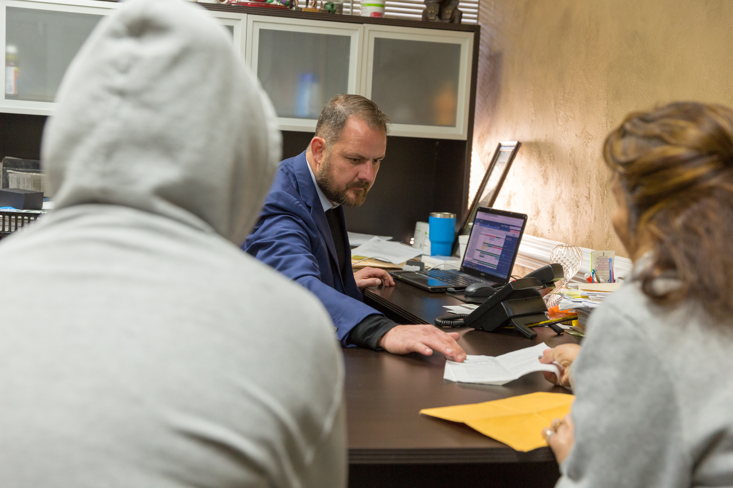 Attorney Christopher Taylor speaks with clients in his office in Norcross, Ga., a suburb of Atlanta. Arrests of immigrants with no criminal record more than tripled in the region last year. (Lynsey Weatherspoon for NPR)