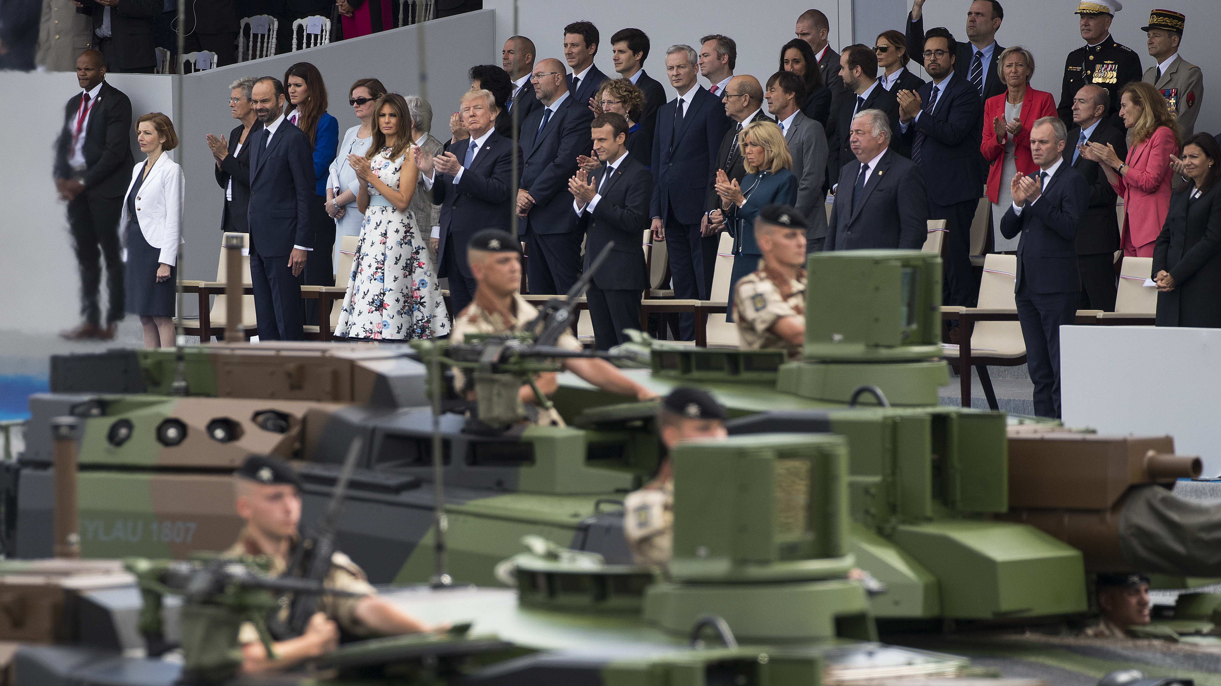 Tanks parade past (front row, center from left) first lady Melania Trump, President Trump, French President Emmanuel Macron and his wife, Brigitte Macron, during the Bastille Day celebrations in July in Paris.